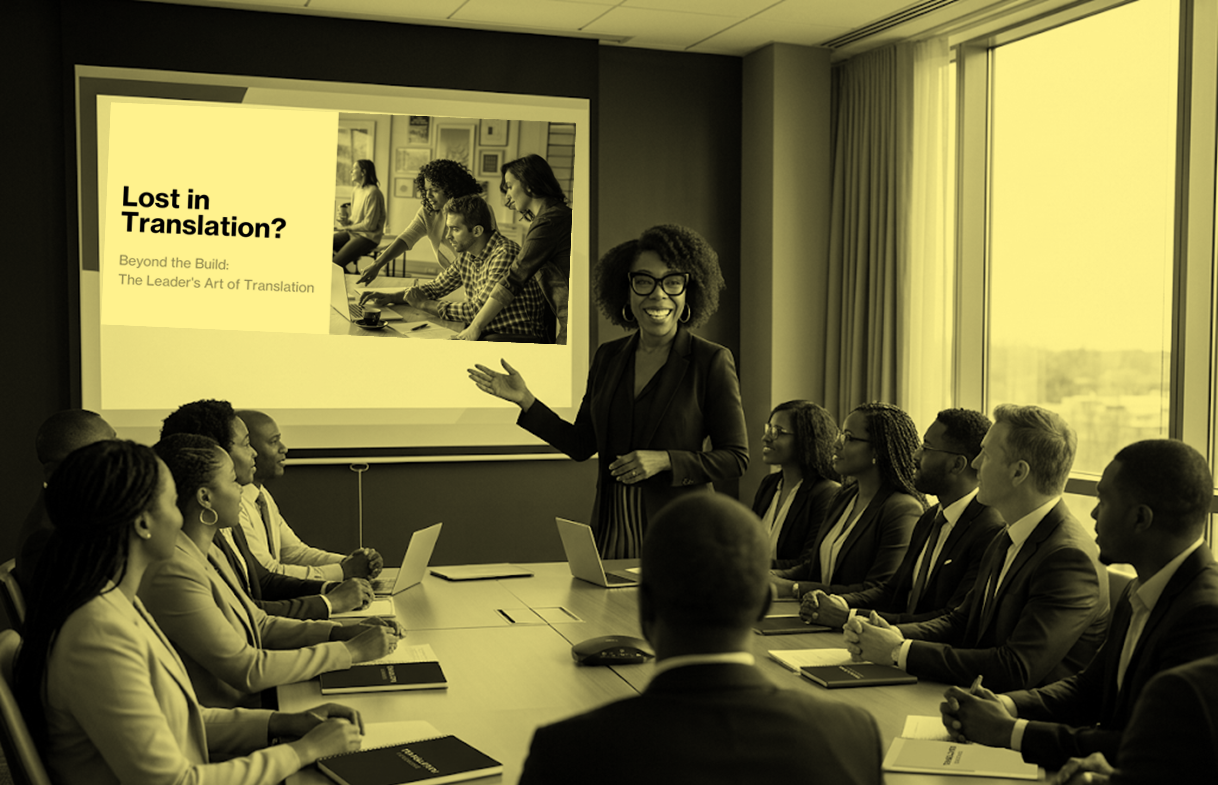 A woman in a blazer giving a presentation in a conference room with several diverse professionals seated around a table, a large window with blinds on the right, and a television screen displaying a slide titled 'Lost in Translation? Beyond the Build: The Leader's Art of Translation' with an image of a team working together.