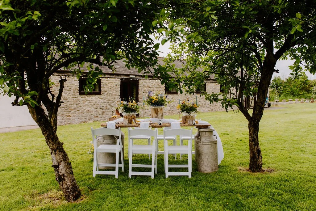 Outdoor wedding dining table at The Old Milking Parlour at Cavokay House with Mae & Maple Prop & Decor Hire