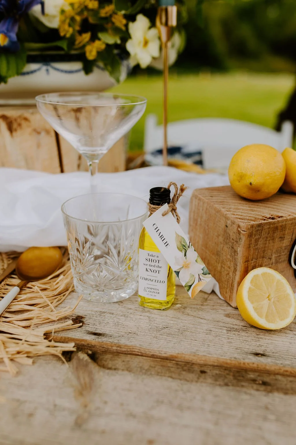 Mini bottle of limoncello with place name on - wedding favour at The Old Milking Parlour at Cavokay House with Mae & Maple Prop & Decor Hire