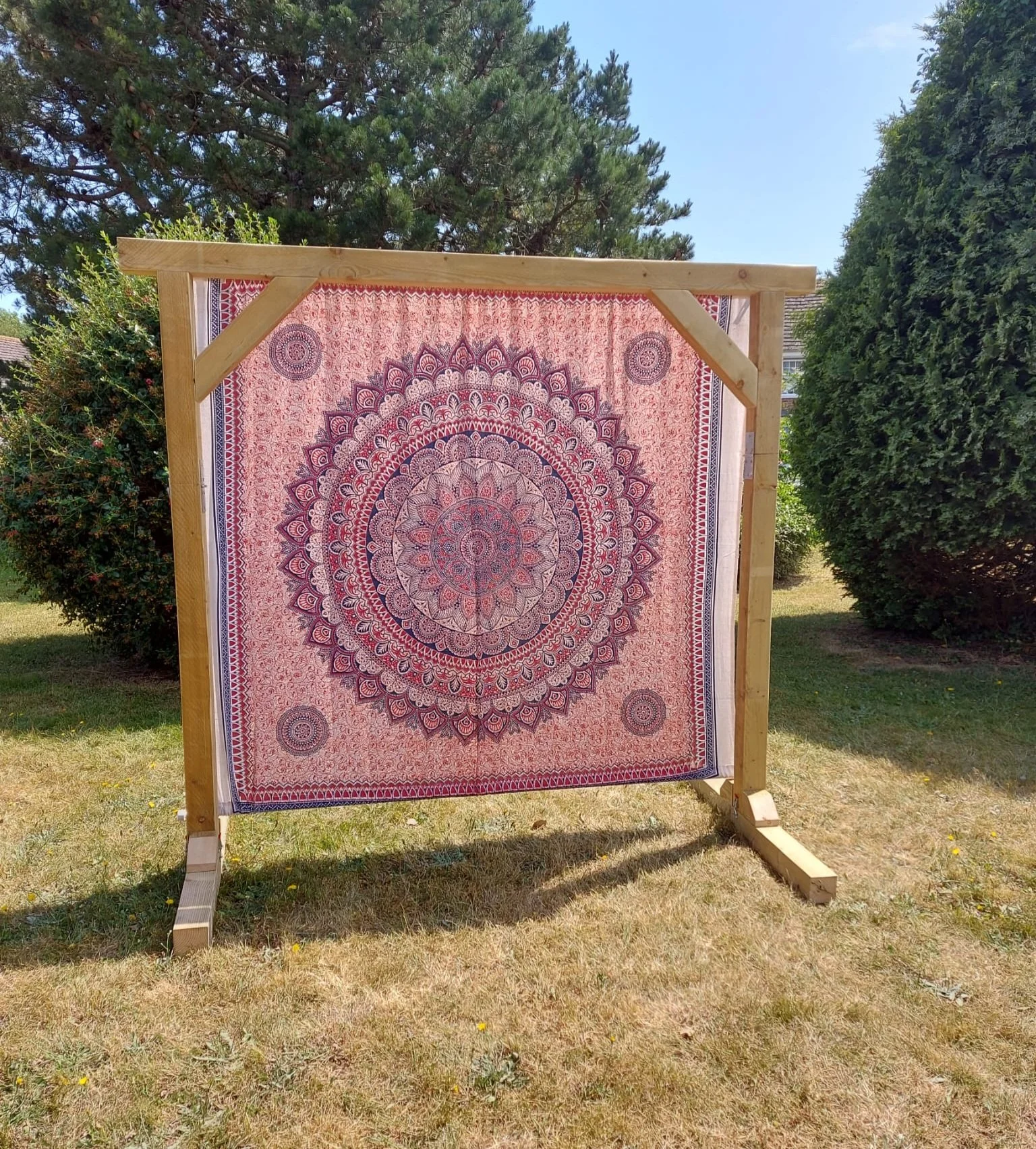 Red boho print backdrop on wooden ceremony arch - hire for Mae & Maple