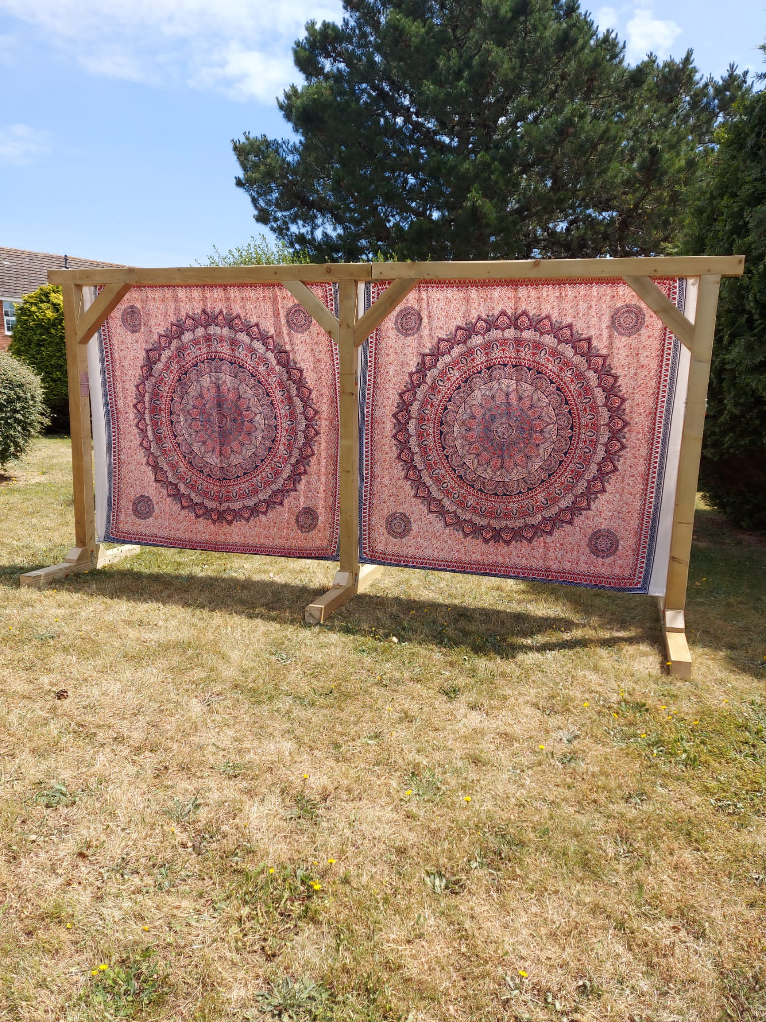 Red boho print double backdrop on wooden ceremony arch - hire for Mae & Maple