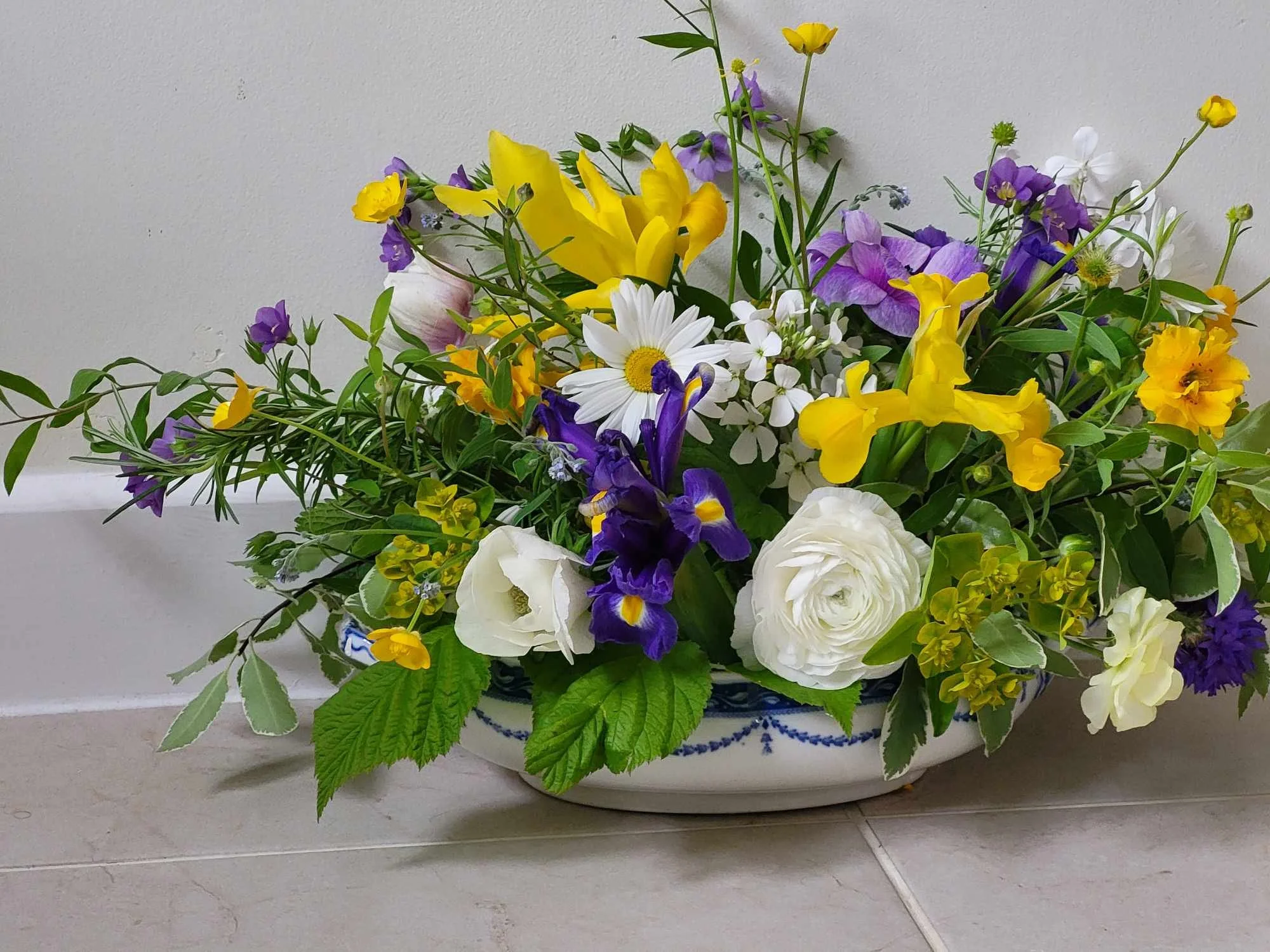 Floral arrangement in blue and white china bowl