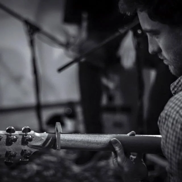Over the Shoulder shot of Nathan Barraclough playing a Maton Acoustic Guitar.