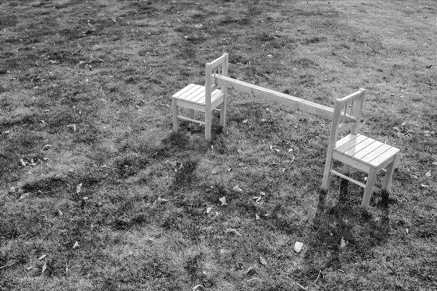 Two small white wooden chairs placed on a grassy field.