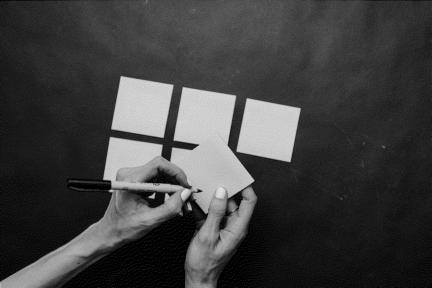 A person drawing a plus sign on a piece of paper in front of four blank sheets, on a dark textured surface.
