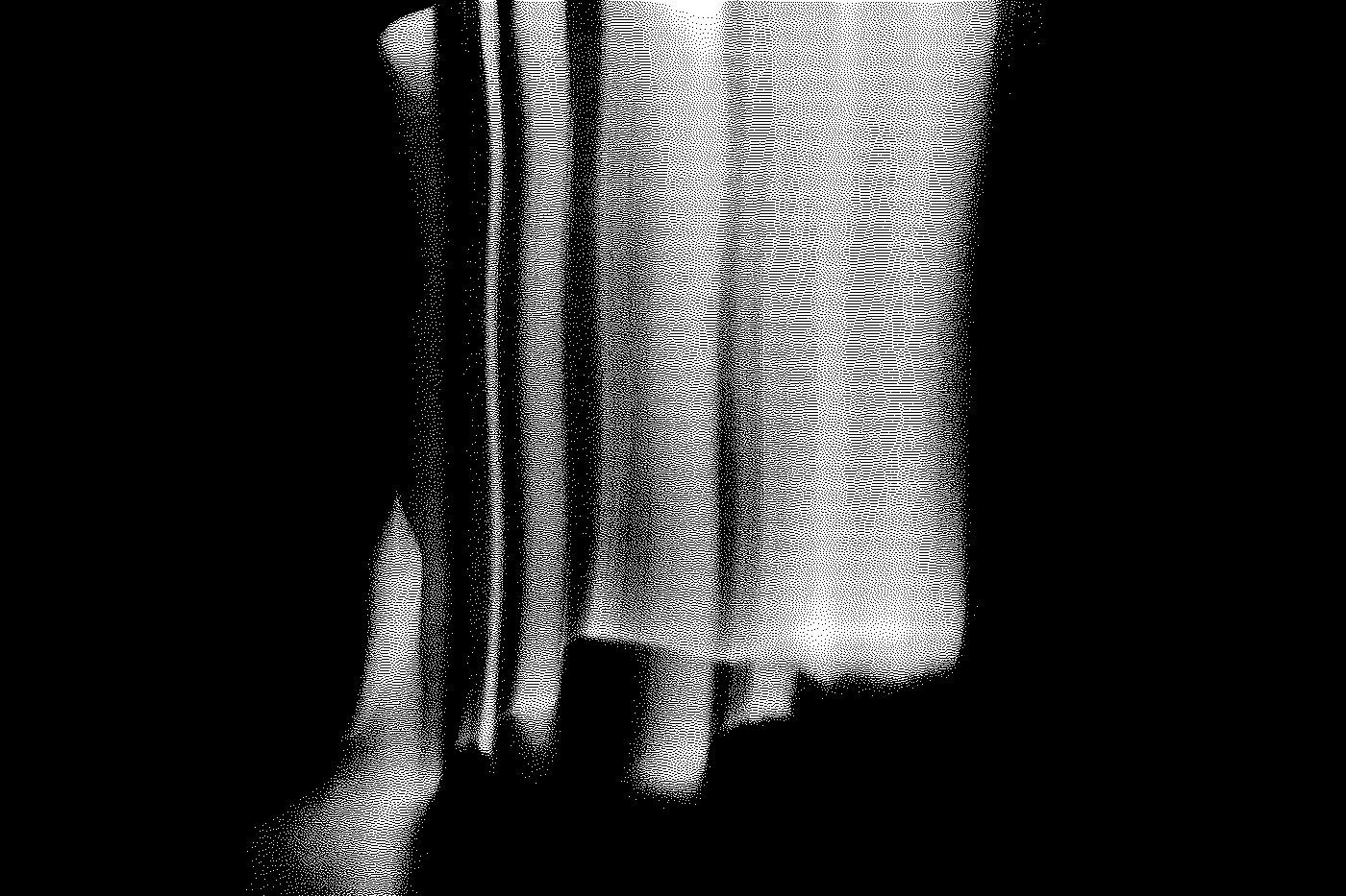 Close-up of a person holding a small book with a patterned cover, wearing a dark shirt.