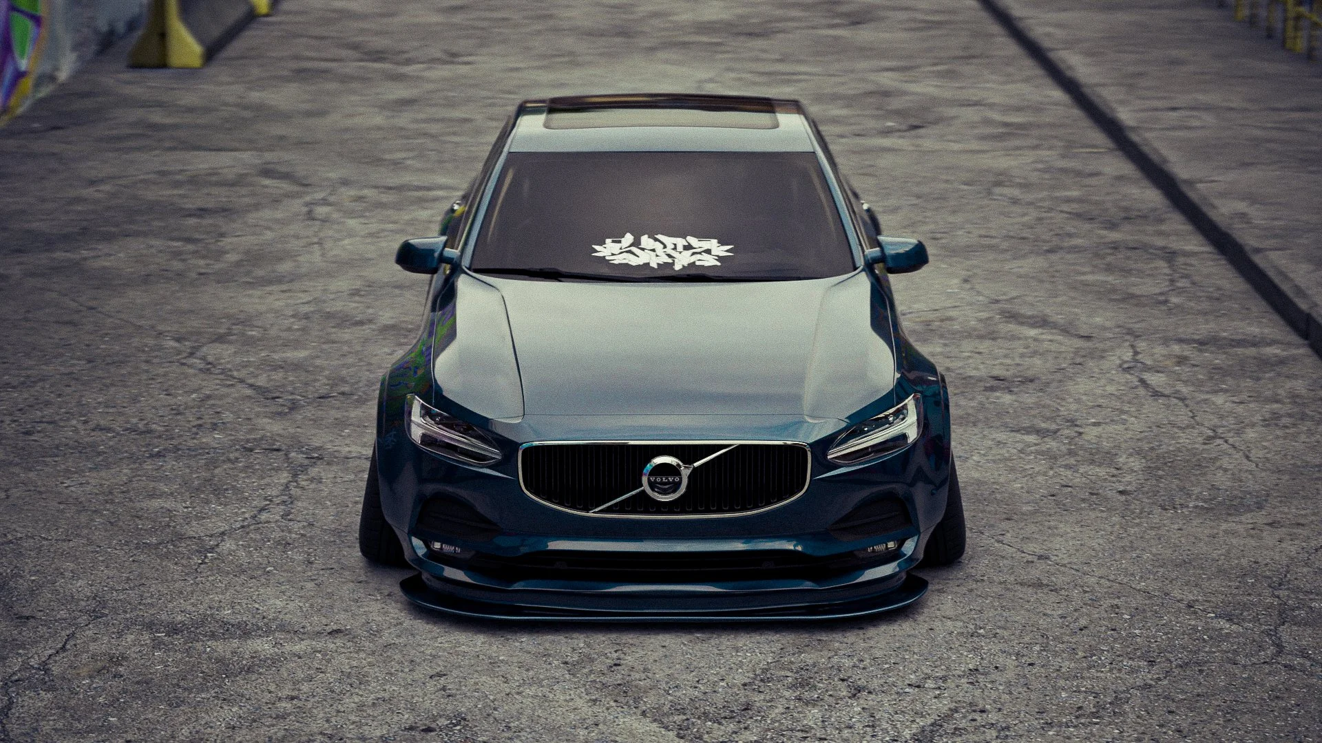 Voiture noire de marque Volvo avec un design modifié, stationnée sur une route asphaltée, vue de face.