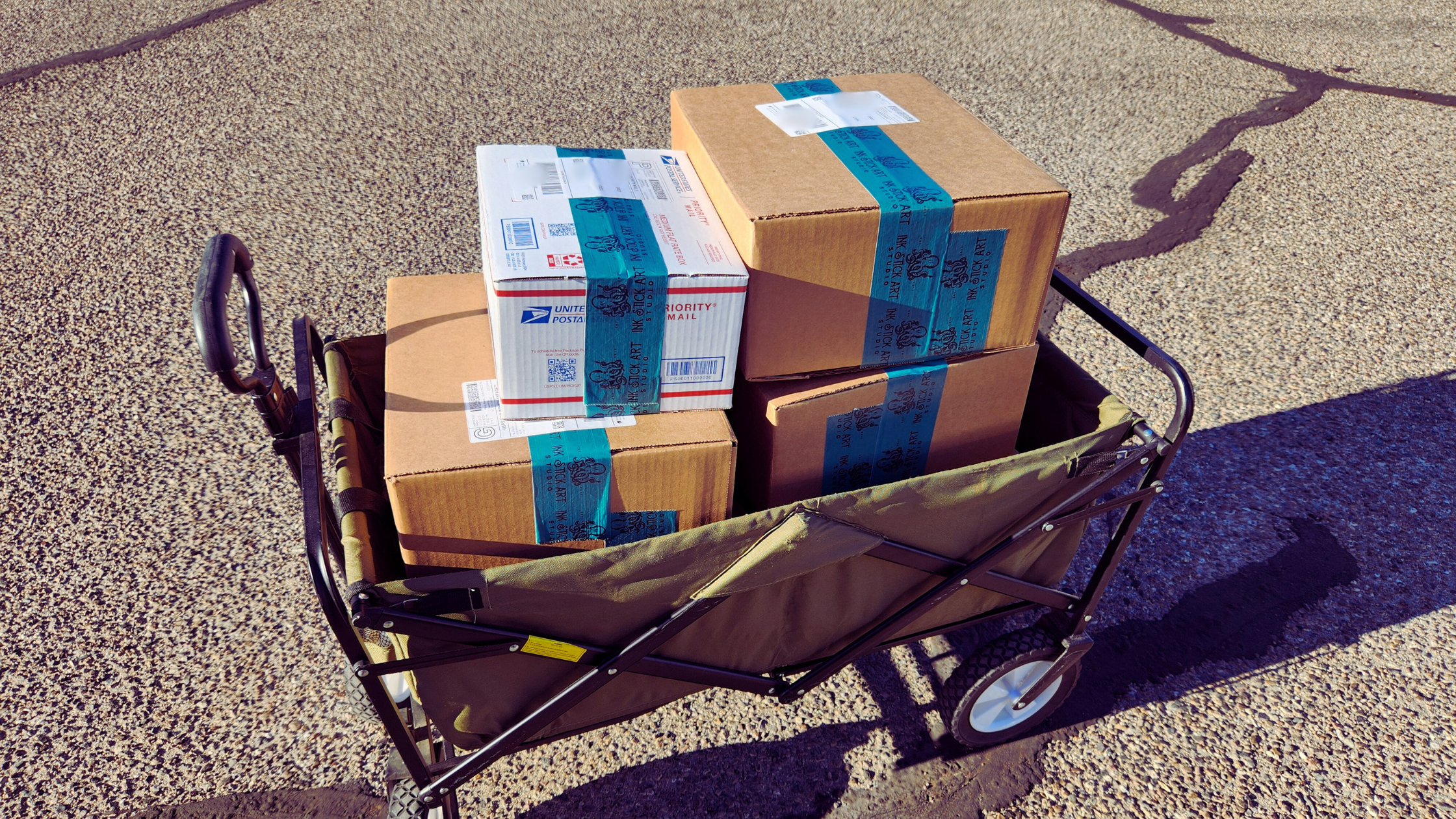 green wagon with shipping boxes in it