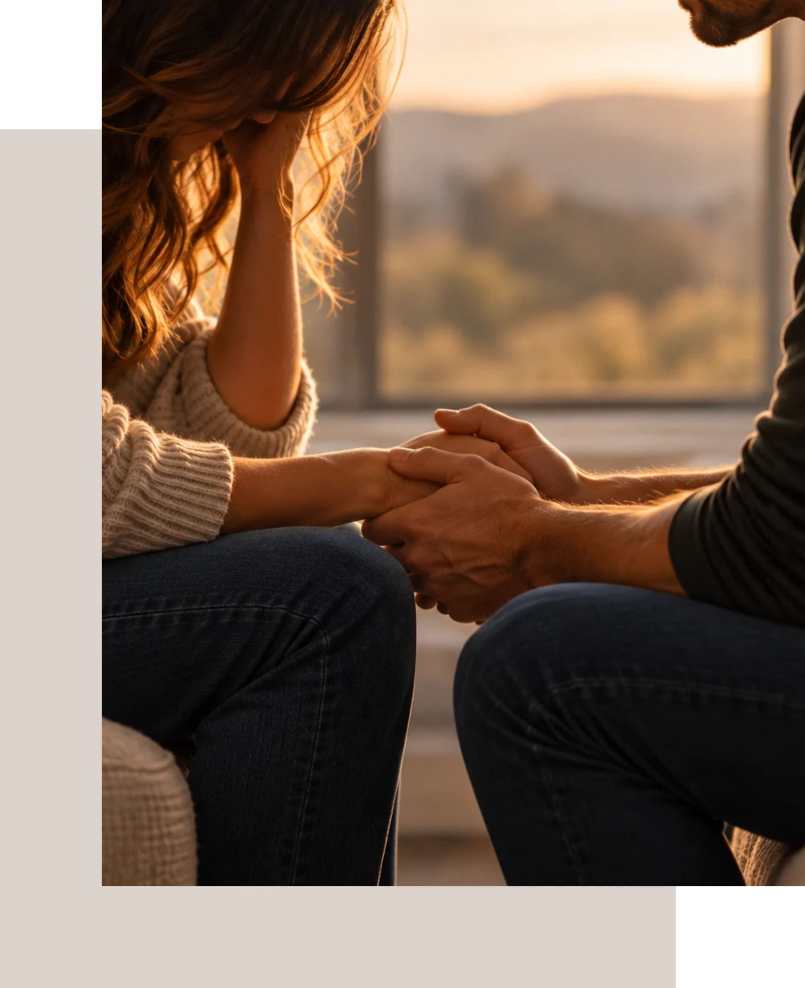 Couple holding hands during a moment of vulnerability and connection, illustrating the attachment-focused work of Emotionally Focused Couples Therapy (EFT).