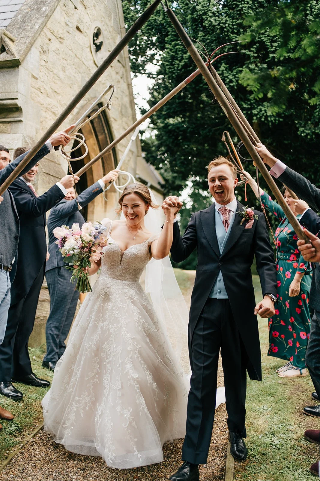 Bride and groom cheering after their church ceremony