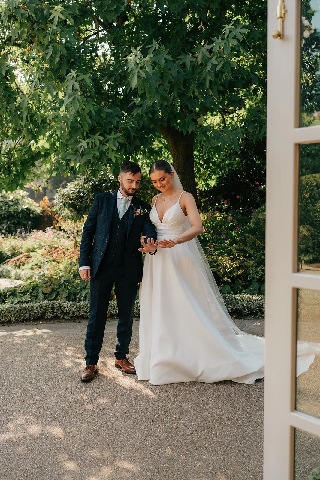 Bride and groom at the ceremony looking at their wedding rings