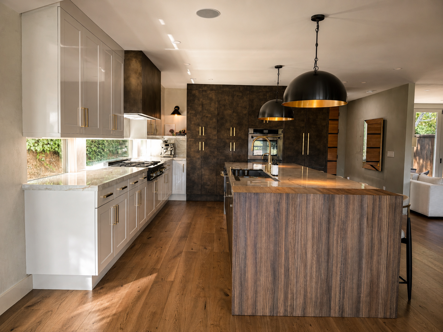 Modern kitchen with white and dark cabinetry, large wooden island, black pendant lights, and hardwood flooring.