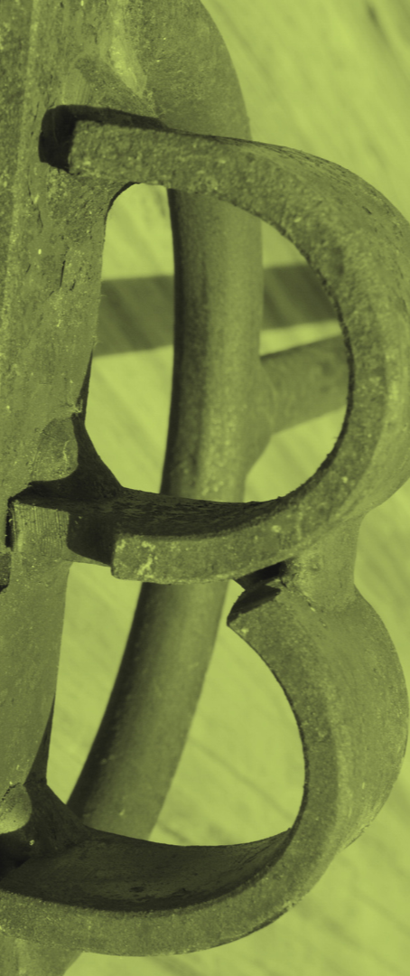 Close-up of a rusty metal hook attached to a wooden surface.