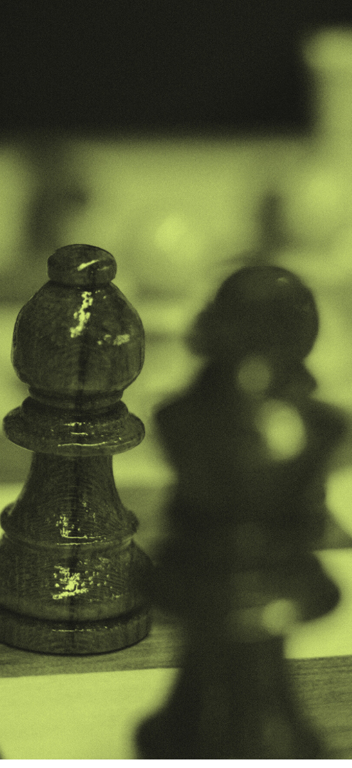 Close-up of a chess pawn on a chessboard with a blurred background
