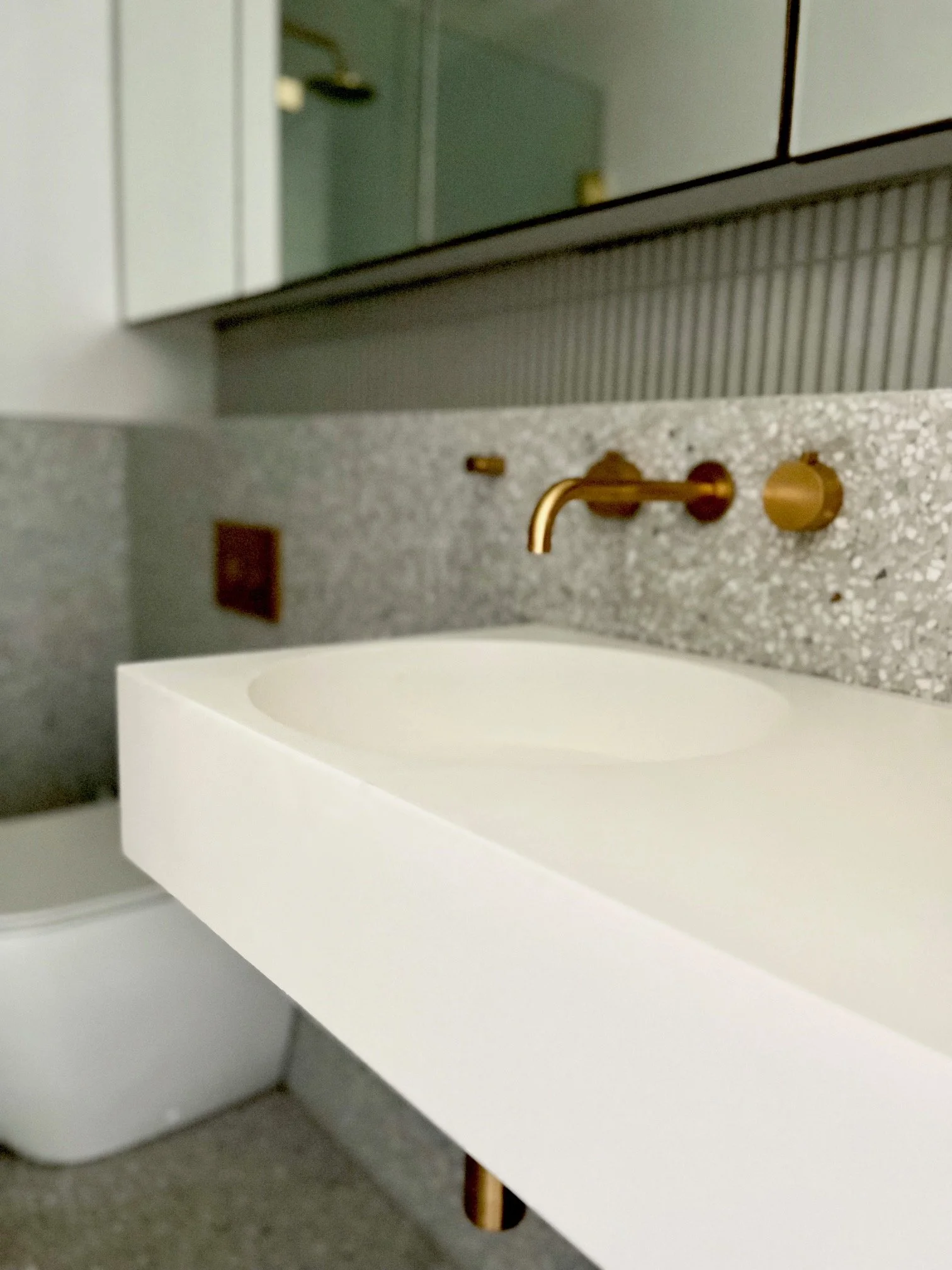 Stone and brass bathroom