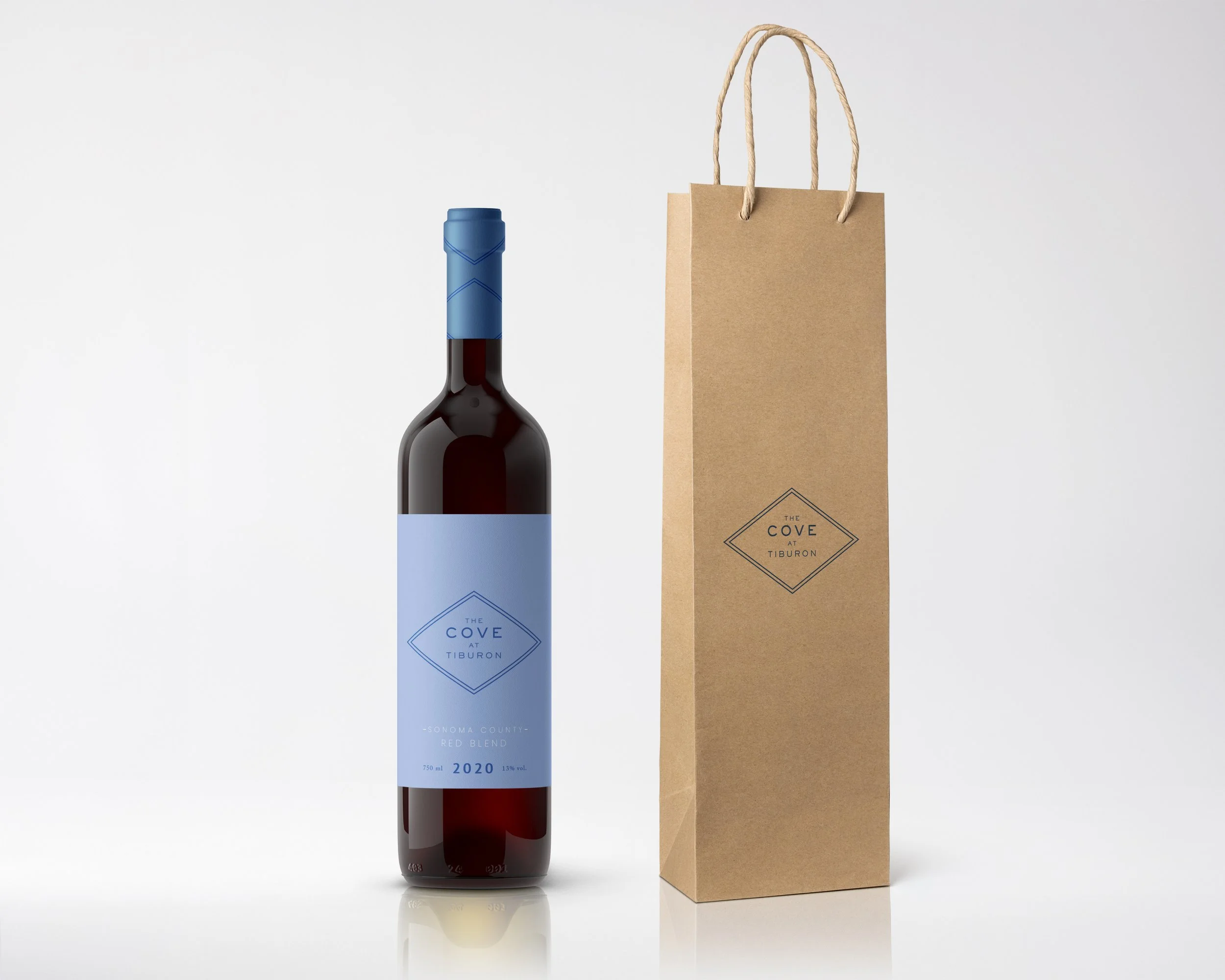 A bottle of red wine with a light blue label next to a brown paper shopping bag with twisted paper handles on a white background.
