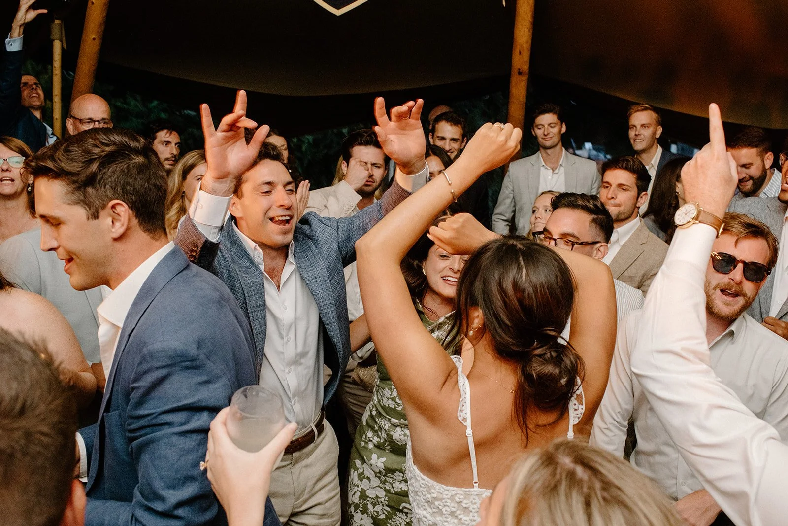 People dancing and celebrating at a party or wedding reception.