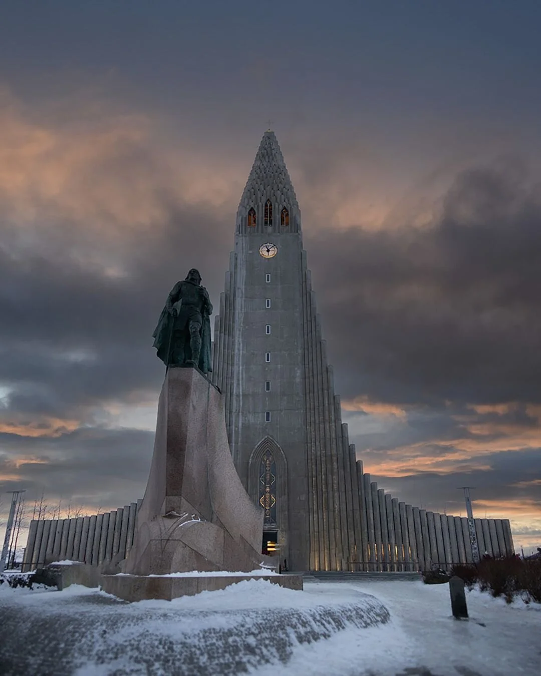 The Hallgr&iacute;mskirkja in Reykjav&iacute;k is a breathtaking sight. There's something almost otherwordly about the concrete fa&ccedil;ade in the fading glow of twilight, rising out of the snow into the sky.