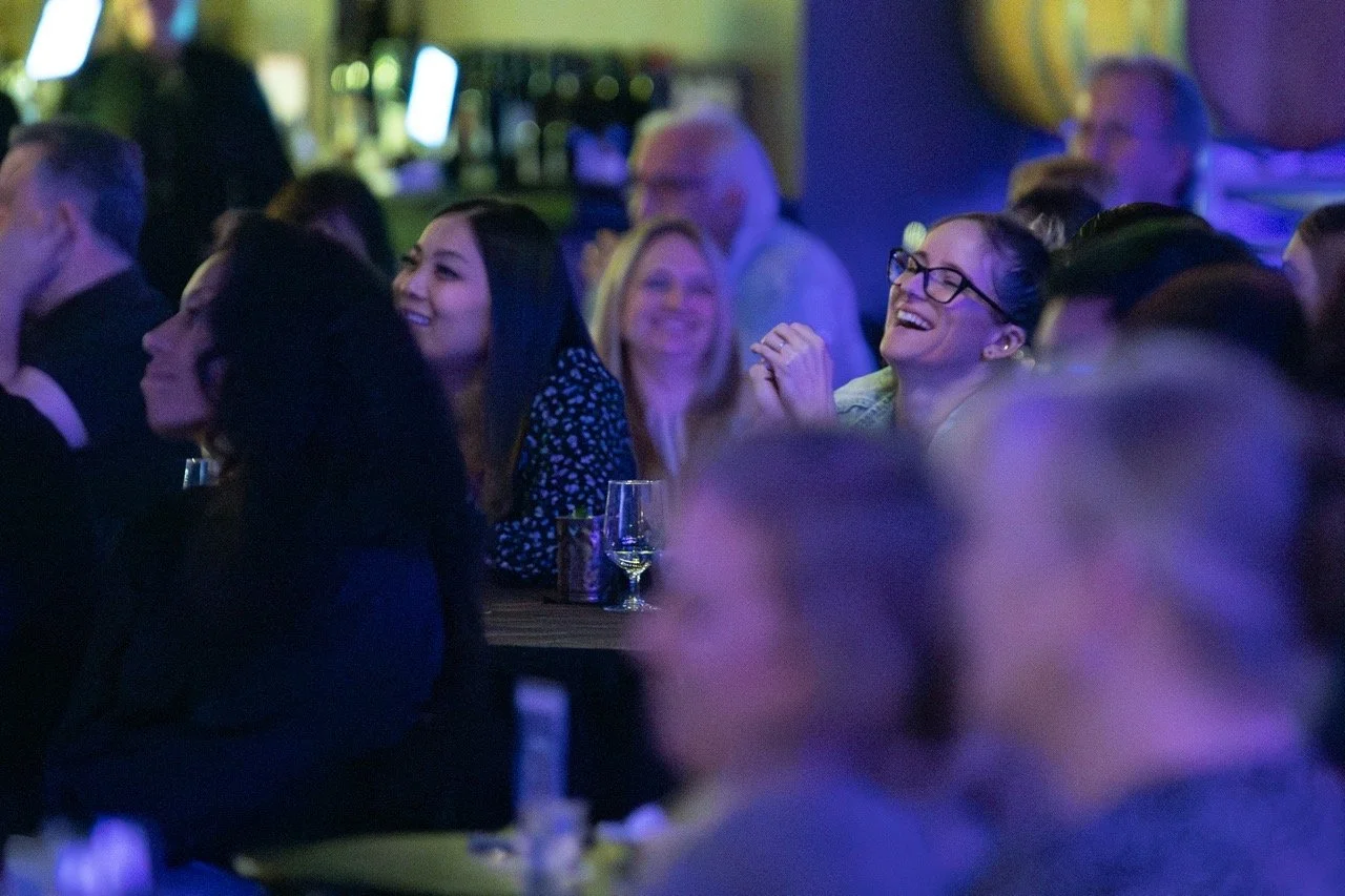 Audience laughing and smiling at an event