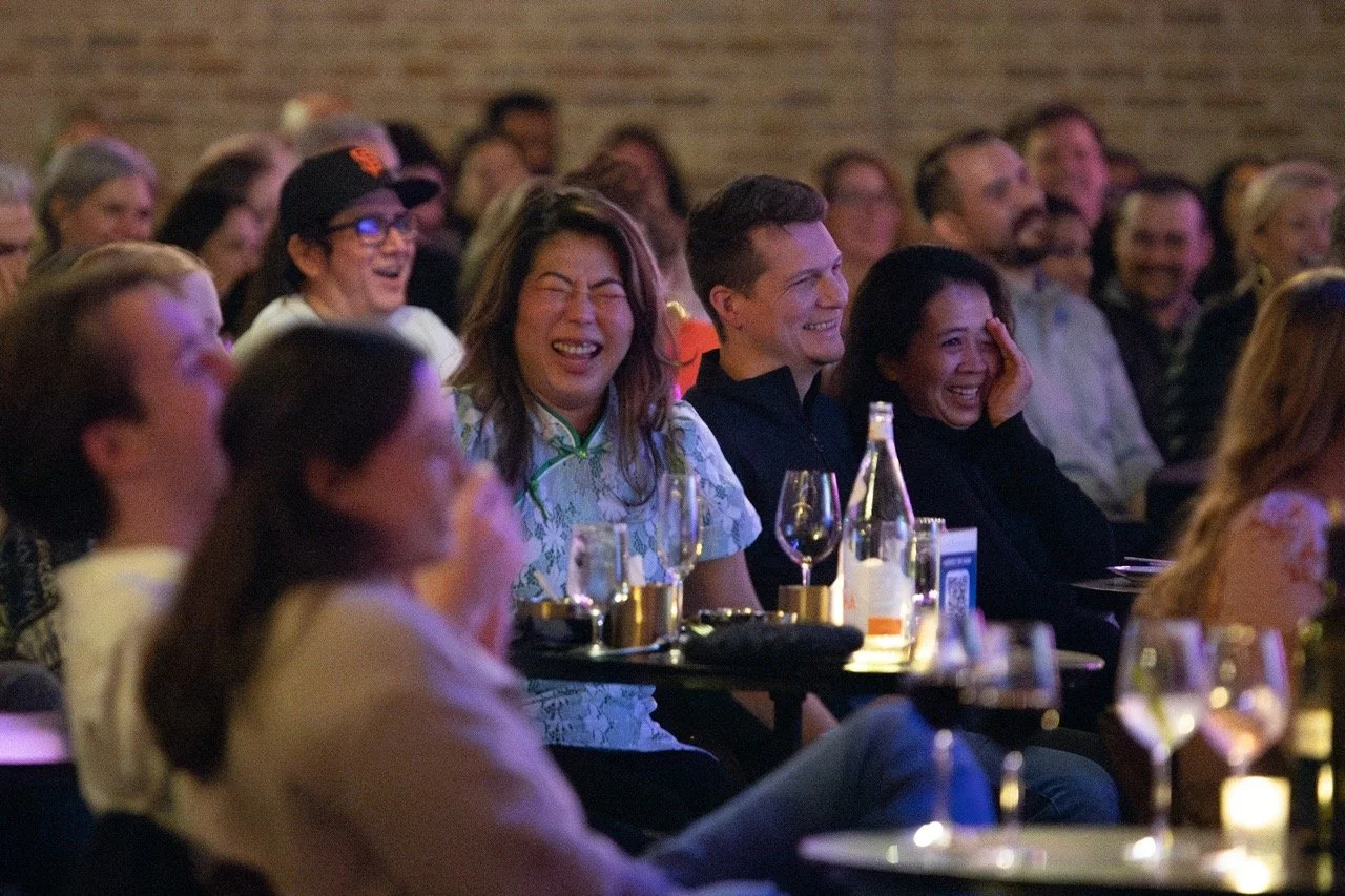 Audience at a comedy show laughing