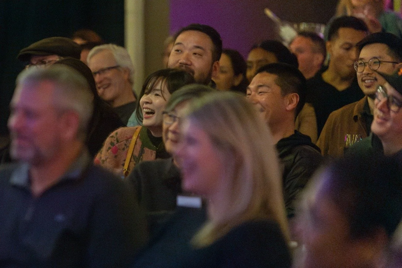 Audience laughing at an event