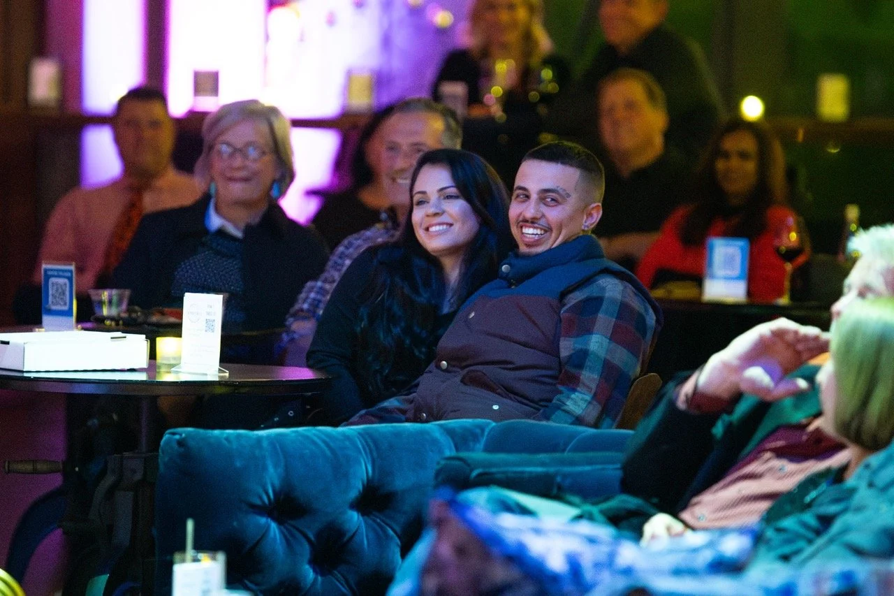 Audience enjoying a live performance in a dimly lit venue.