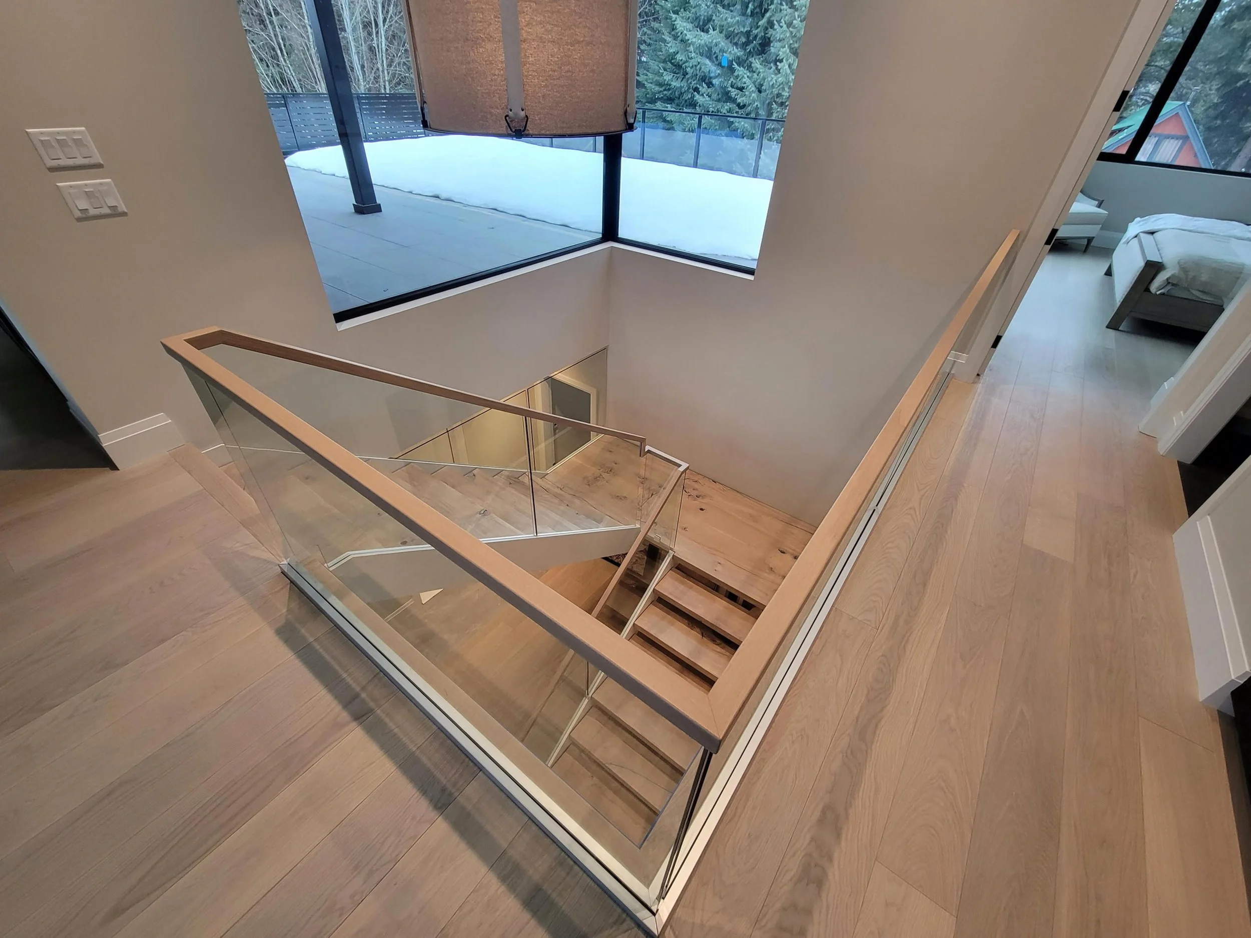 Architecturally striking White Gold custom home featuring a single-tree oak staircase, mountain-facing decks, and high-performance, durable materials for modern mountain living.