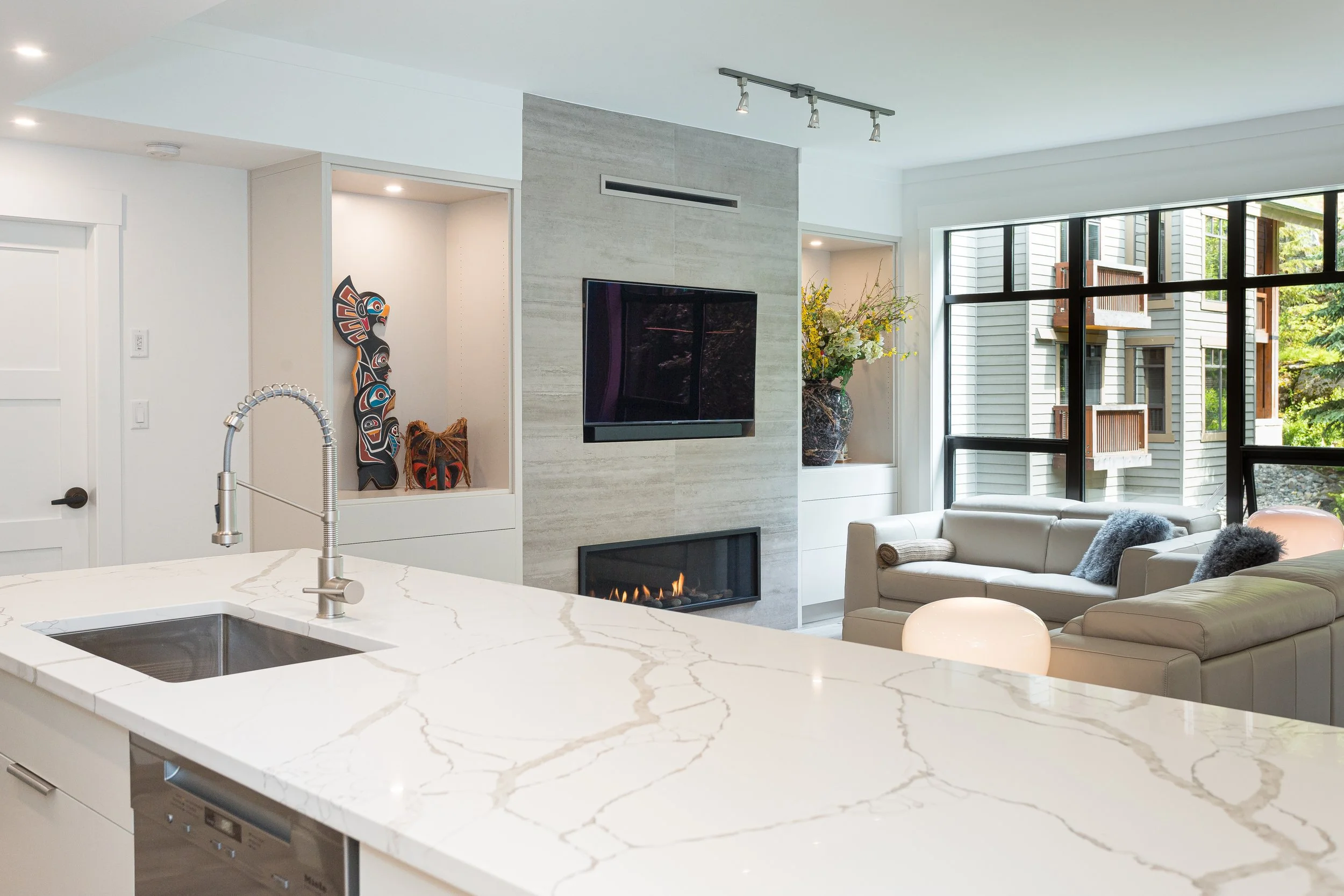Interior of modern First Track condos in Whistler showing renovated kitchens, living spaces, and fireplaces by Golden Spruce.