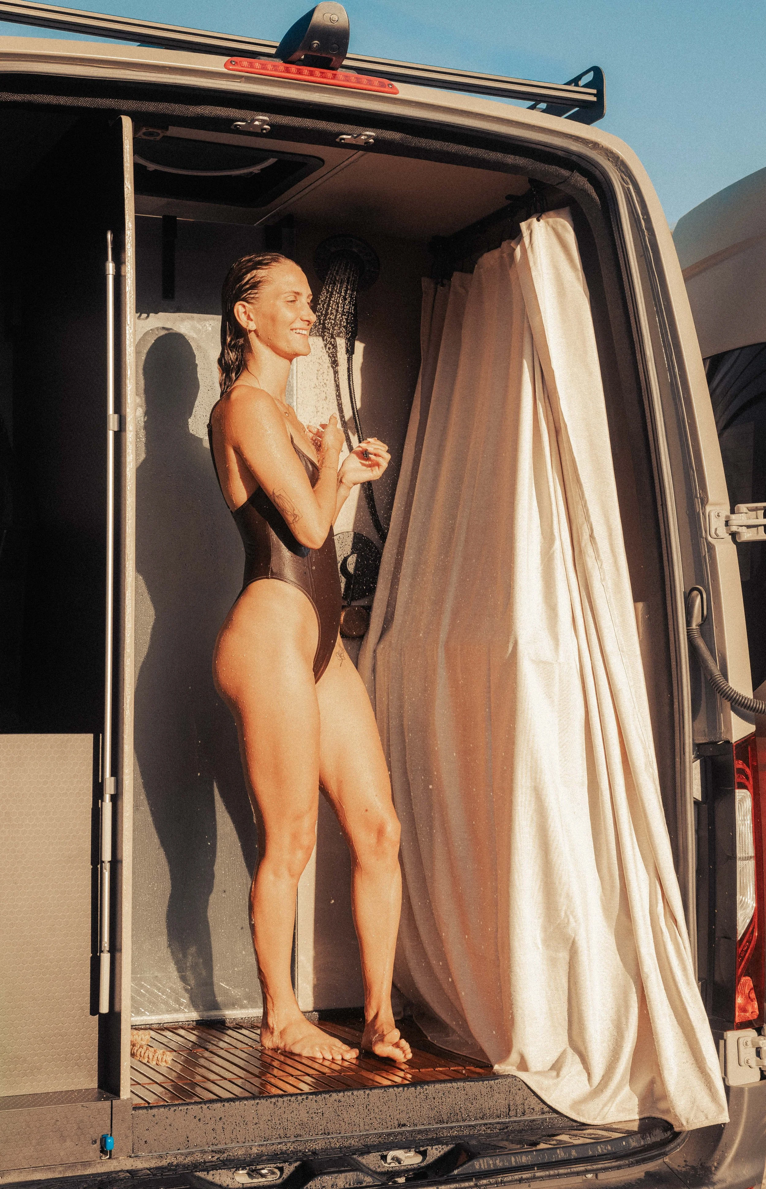 Concrete Oasis high end campervan interior view with full luxury spa shower