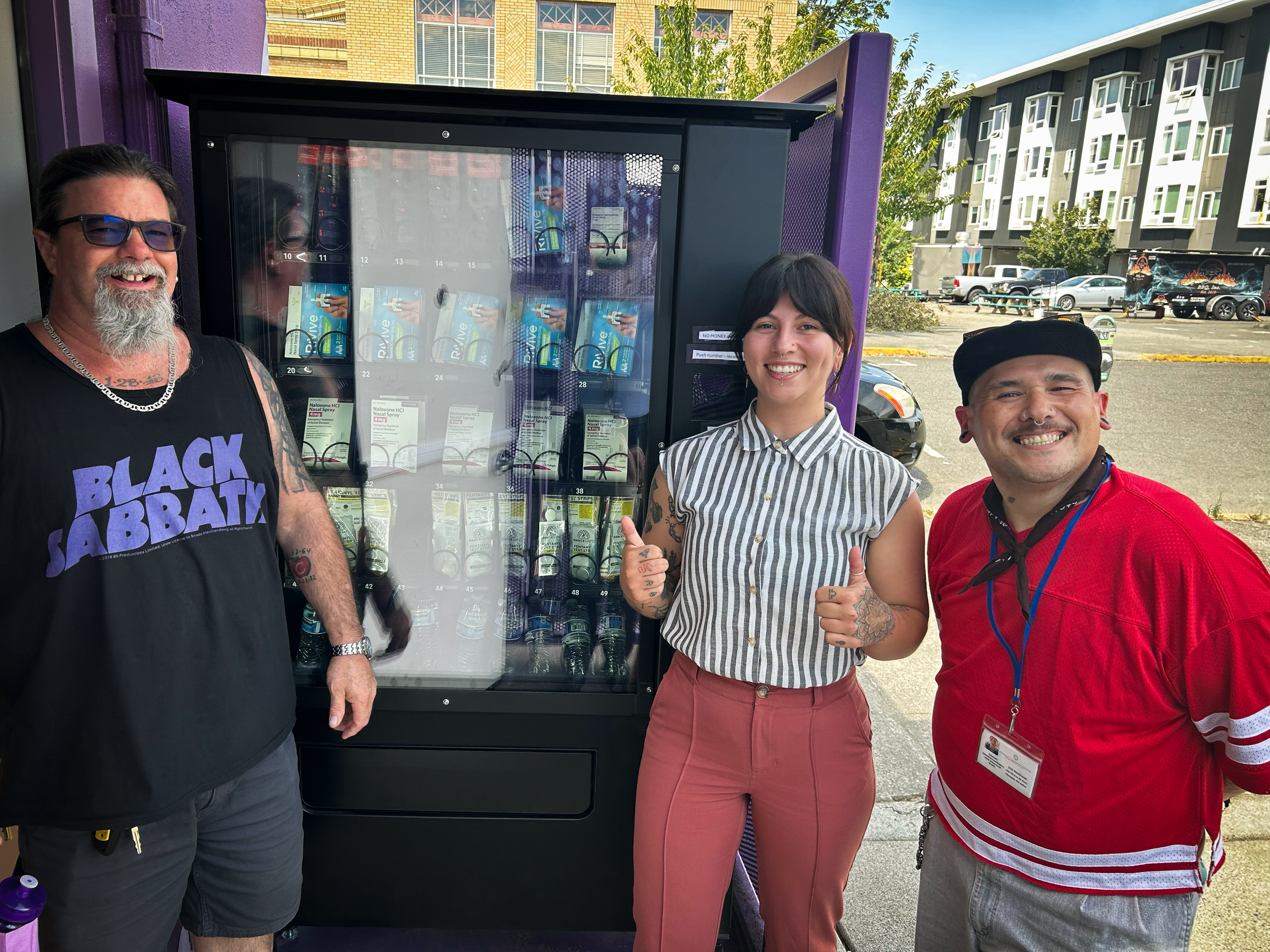 Commissioner Emily Clouse with community leaders near a narcan and lifesaving supplies vending machine