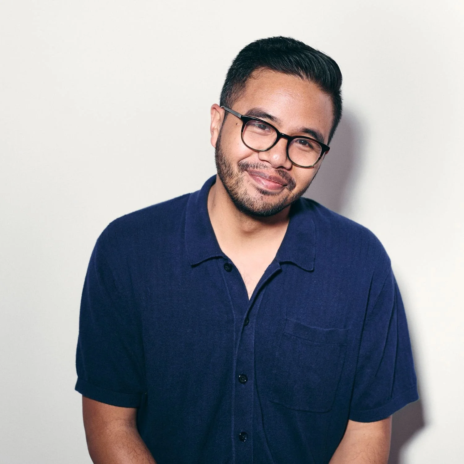 man with glasses in a black shirt