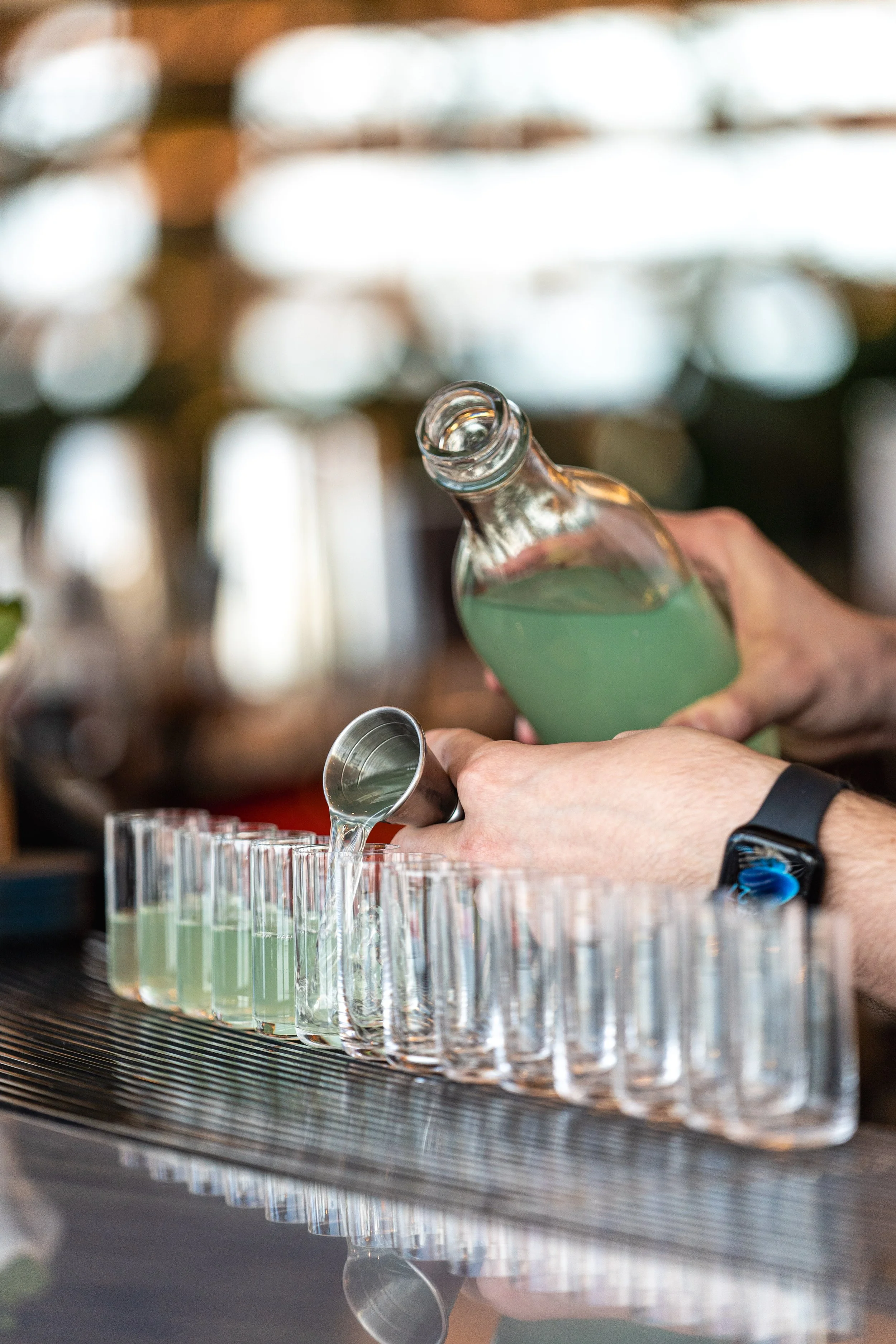 Pouring beverage into shots