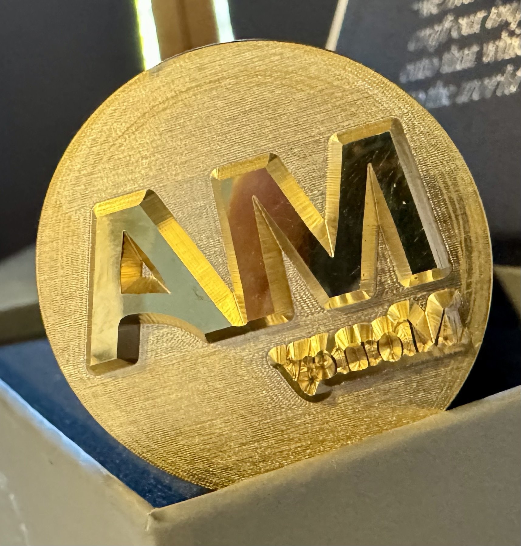 Custom gold ice stamp with engraved MA Money logo