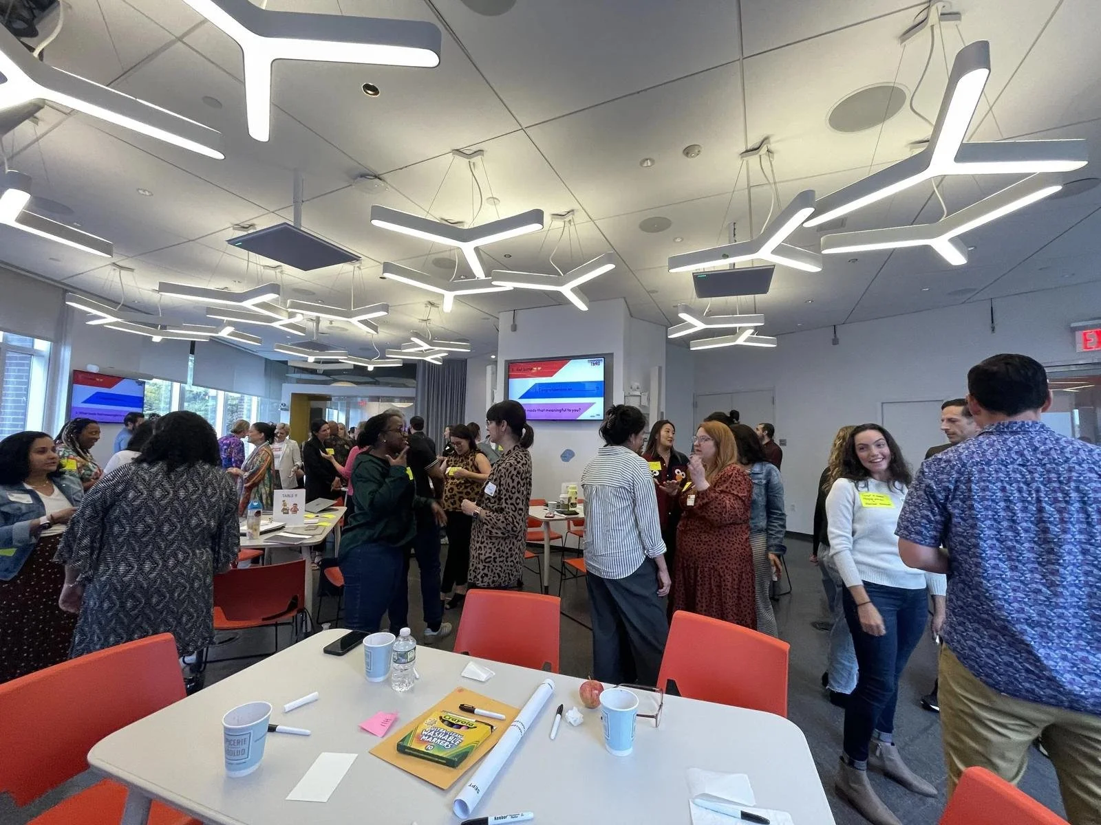 Workshop attendees mingling and sharing stories during an interactive culture session