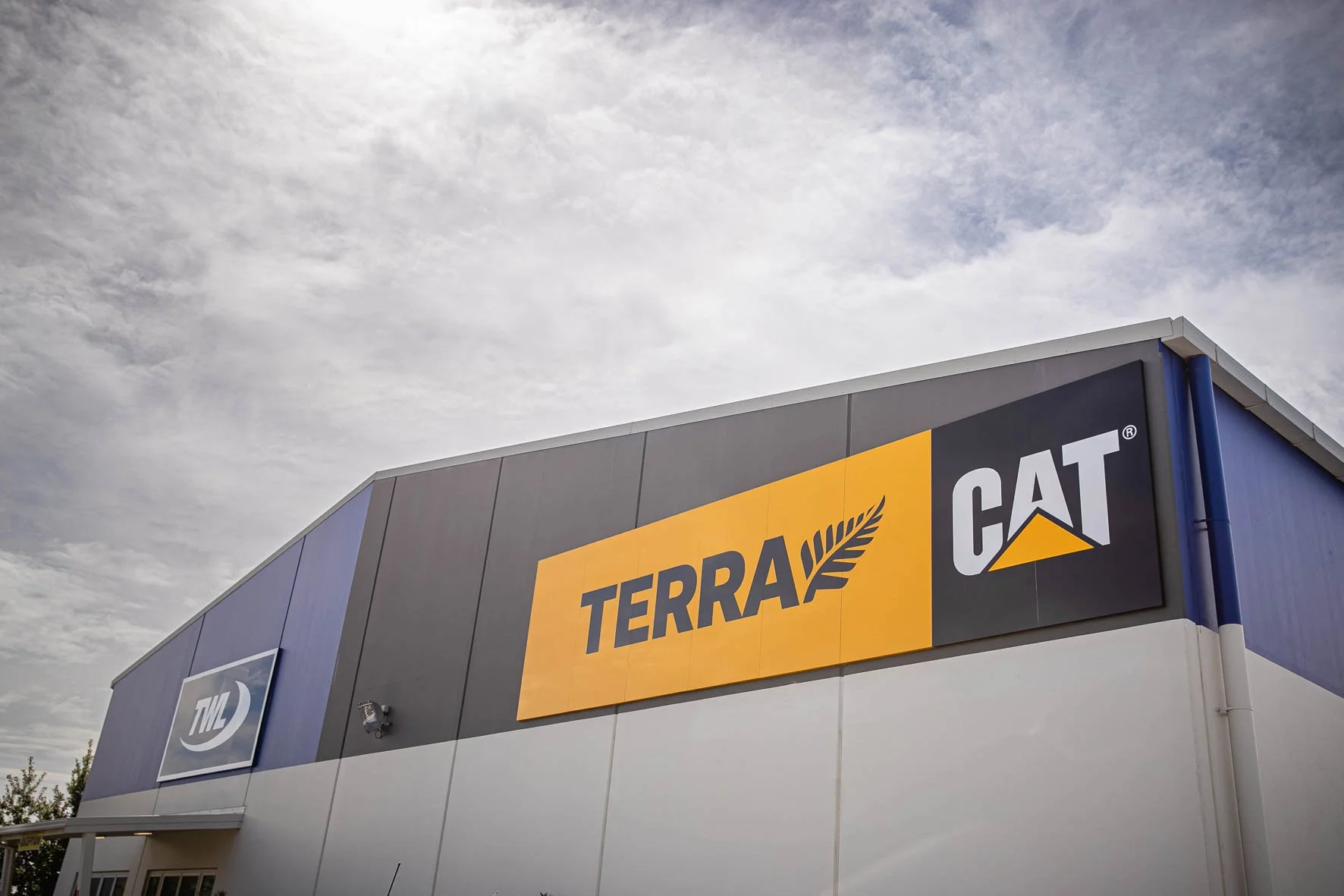 Exterior of a building with signage displaying the logos and names of Terra and CAT.