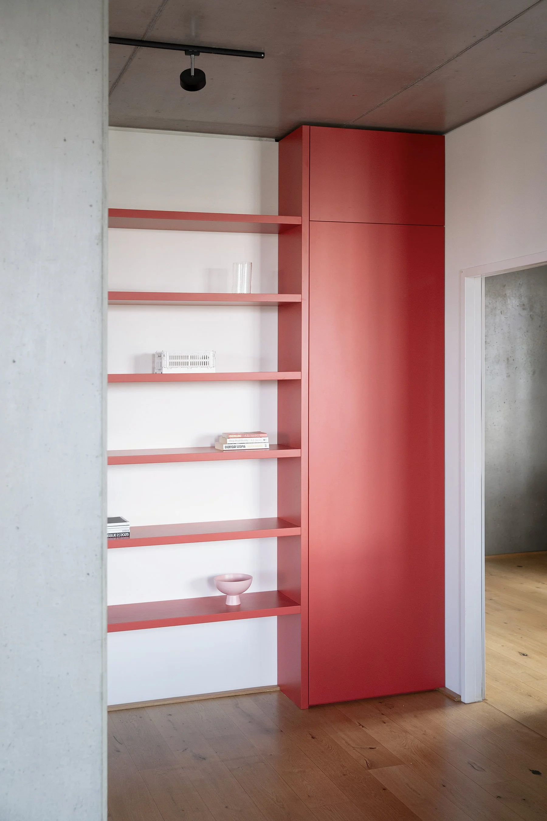 A custom built-in shelf in Farrow & Ball Romesco, Kreuzberg Berlin