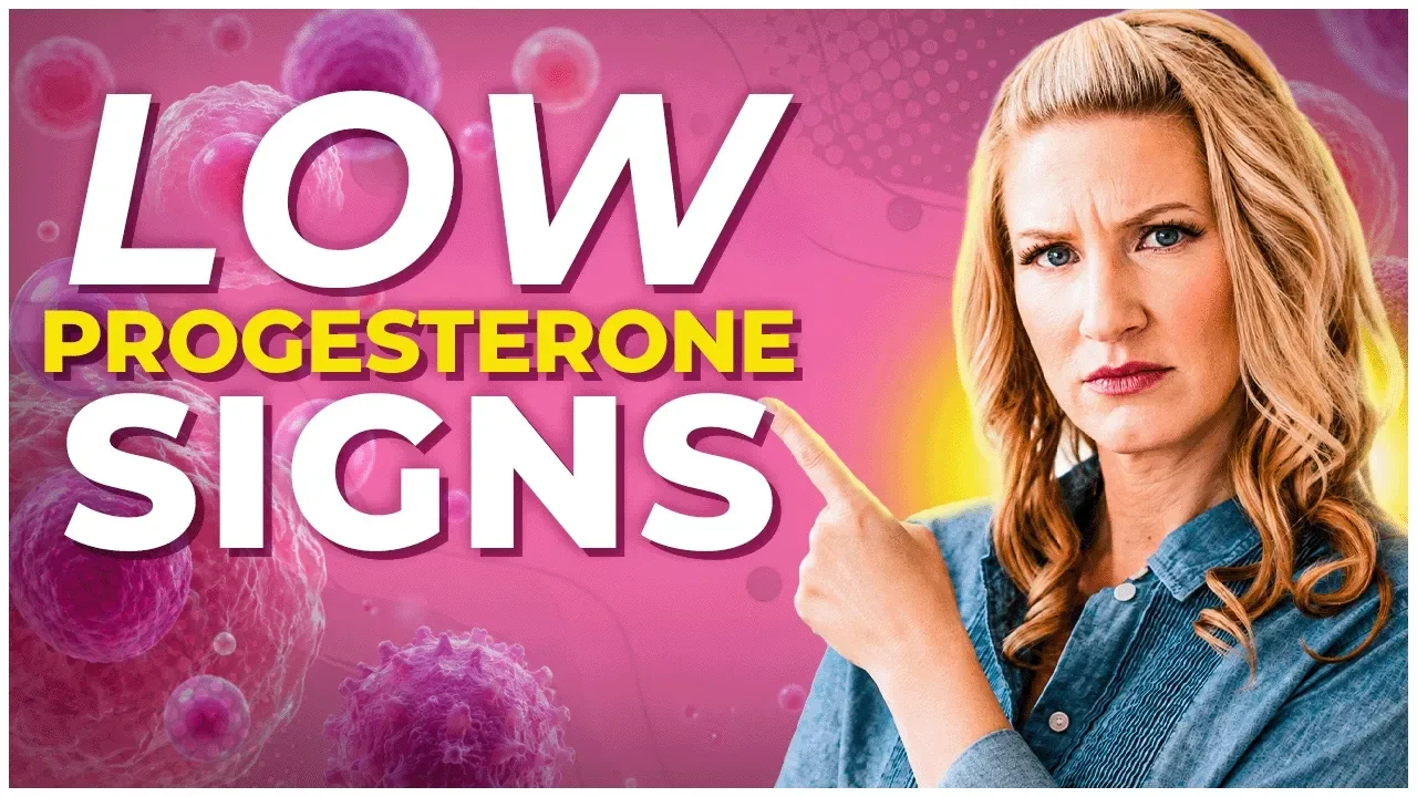 Dr Carrie in a denim blouse with a pink background pointing at the words Low Progesterone Signs for youtube thumbnail