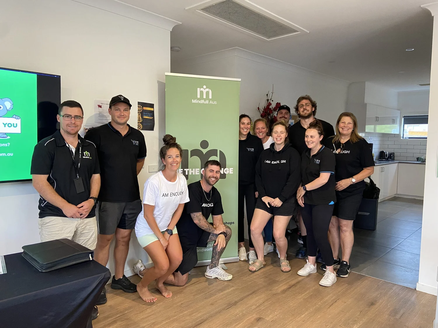Smiling team members standing together in a bright modern office