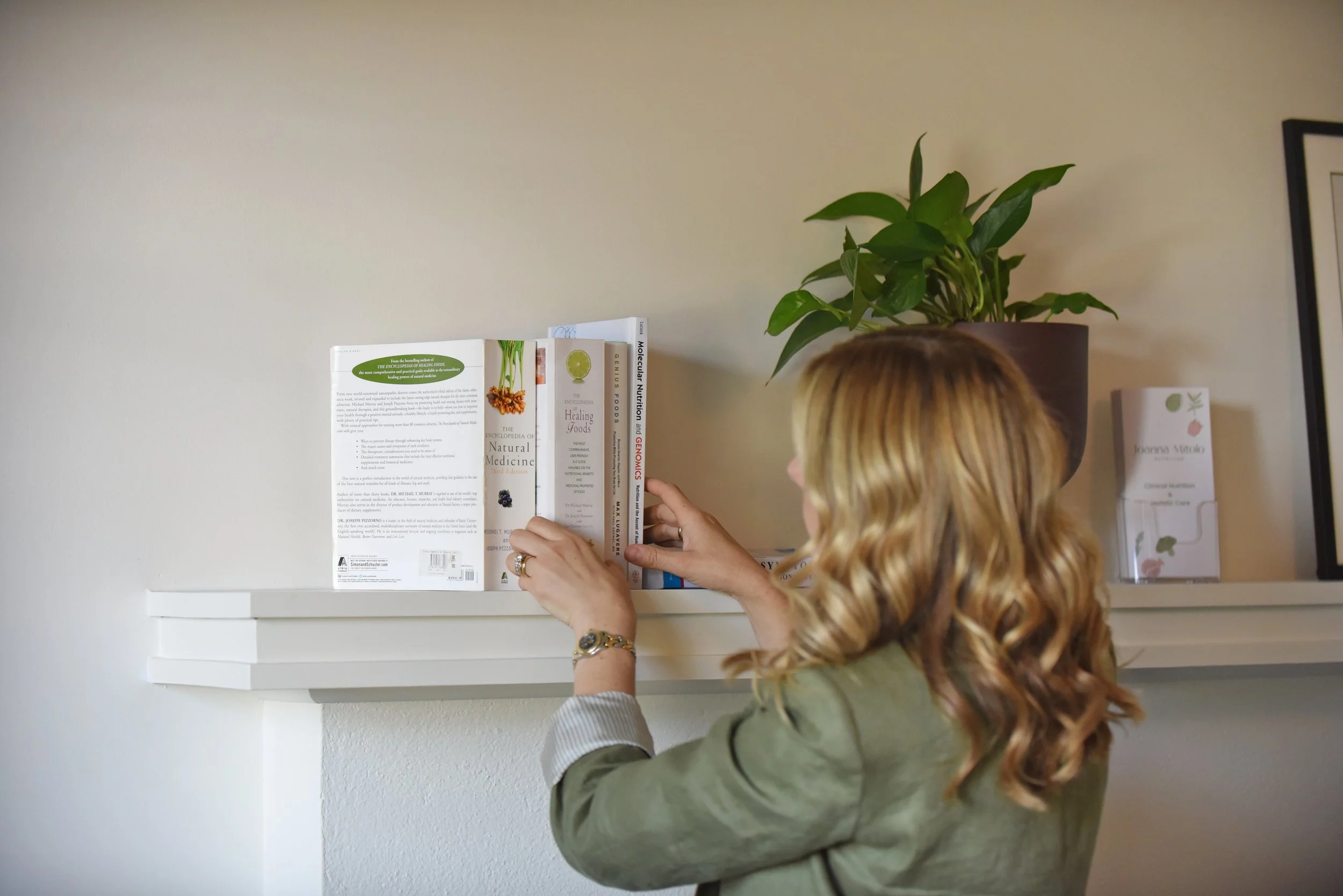 Joanna Mitolo arranging nutrition books on a shelf