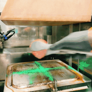 The Chef is seen placing the raw beef balls on the griddle which starts cooking automatically as the griddle moved up to smash them into burger patties. Once patties are grilled, the griddle moves down, and chef places the cheese for melting.
