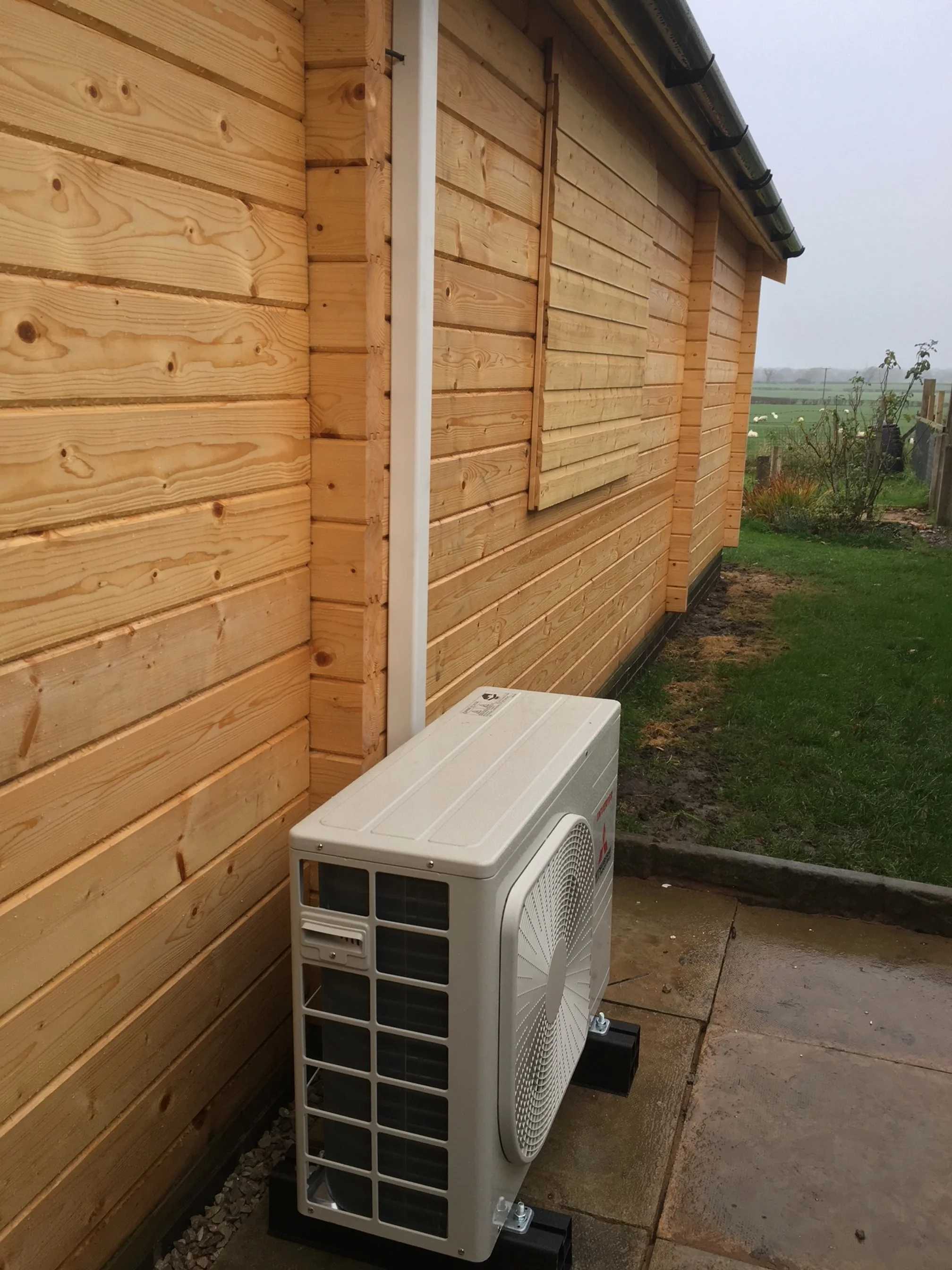 exterior of a garden room showing exterior part of an air conditioning unit