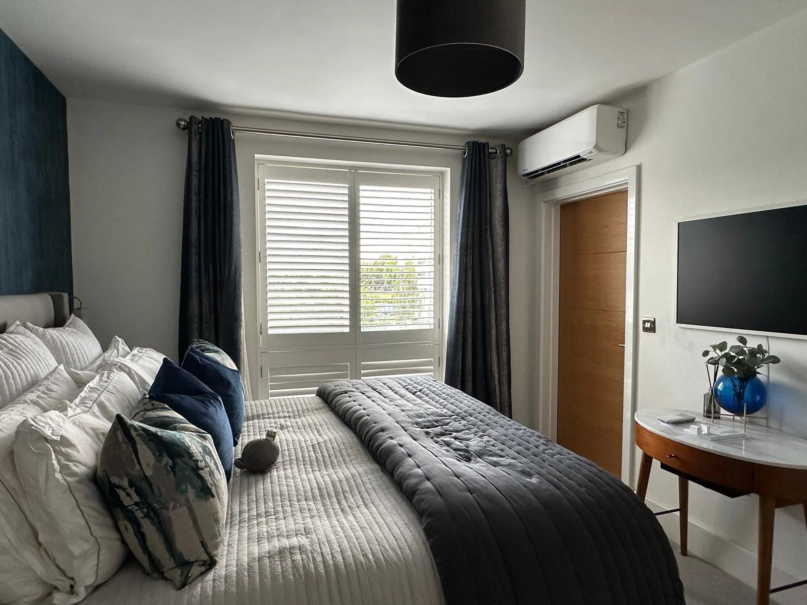 compact air conditioning above bedroom door