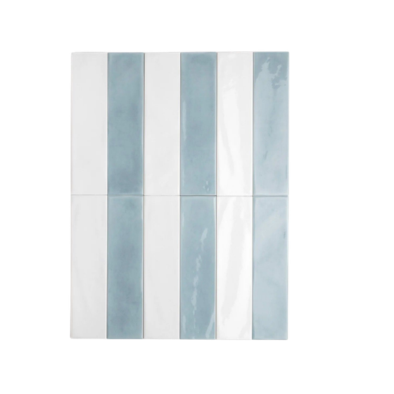 A wall of vertically aligned bathroom tiles in shades of white and light blue, with a glossy finish.