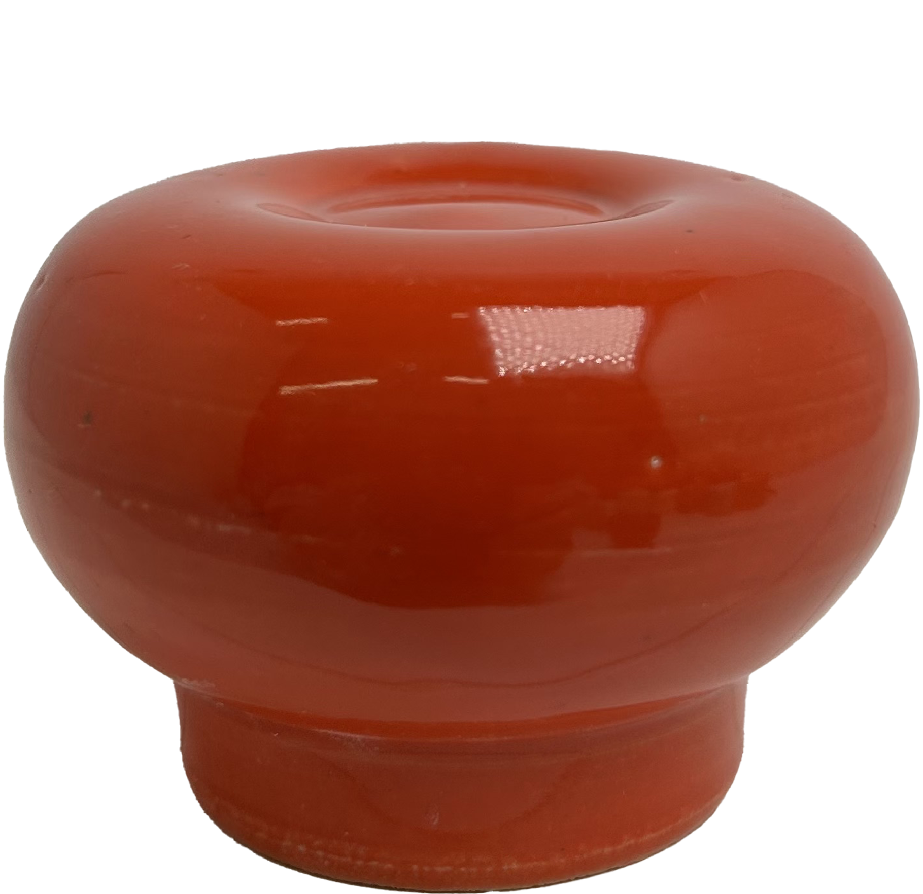 Close-up of glazed ceramic object. It used as an example to indicate the appearance of the glaze. The glaze is red