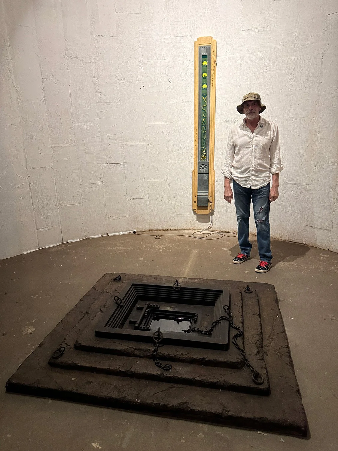 Steve Brudniak by his artwork "Djet" (wall) and "The Gulf of Pandemonium" (floor)