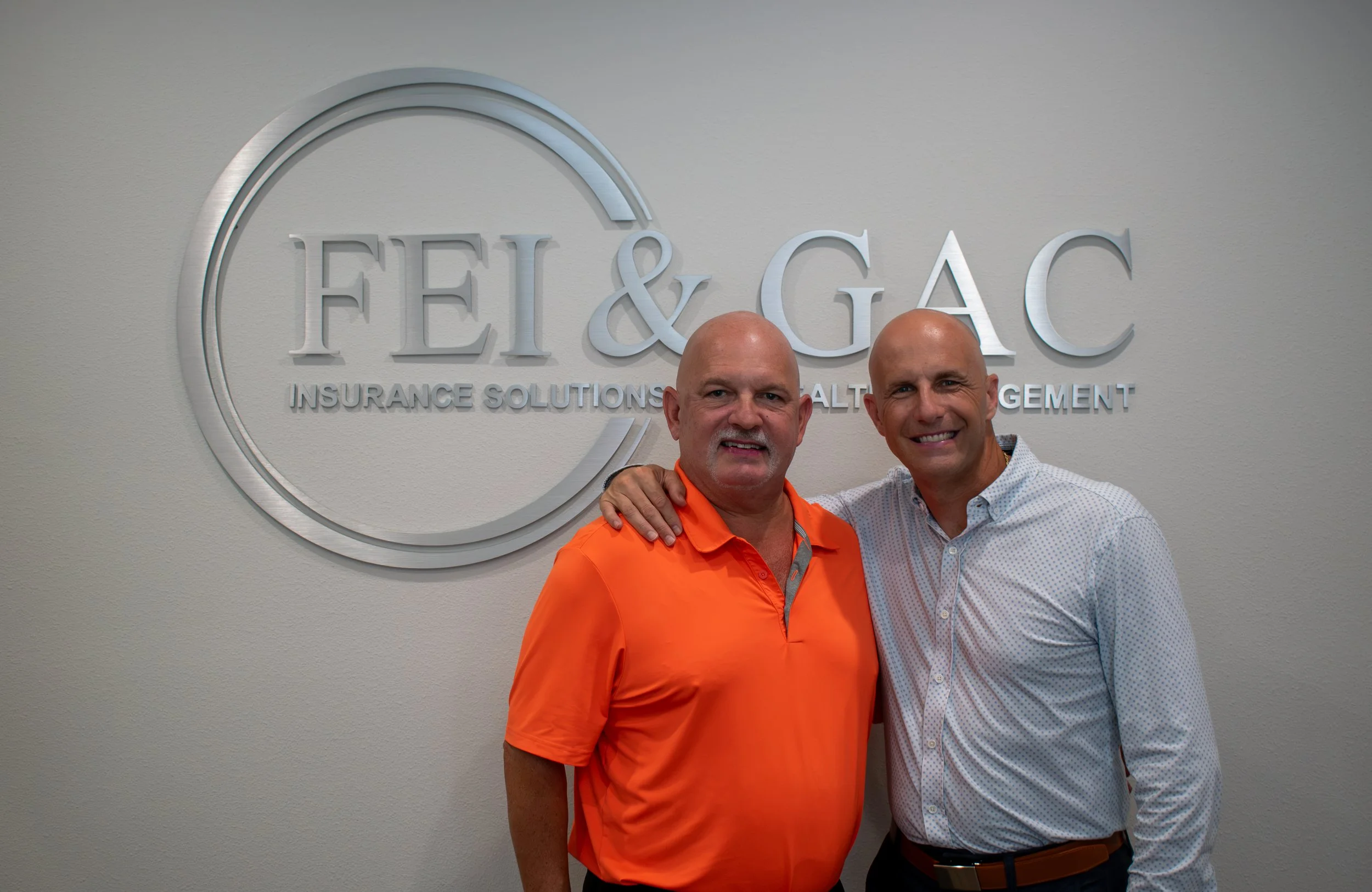 Gary Cucchi and Tad Cromley in front of FEI & GAC logo