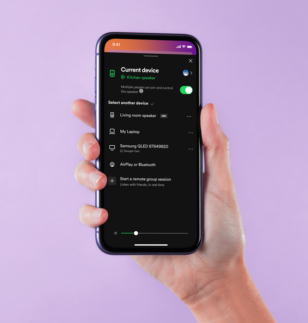 Hand holding a smartphone showing the Bluetooth device connection menu on the screen, with a purple background.