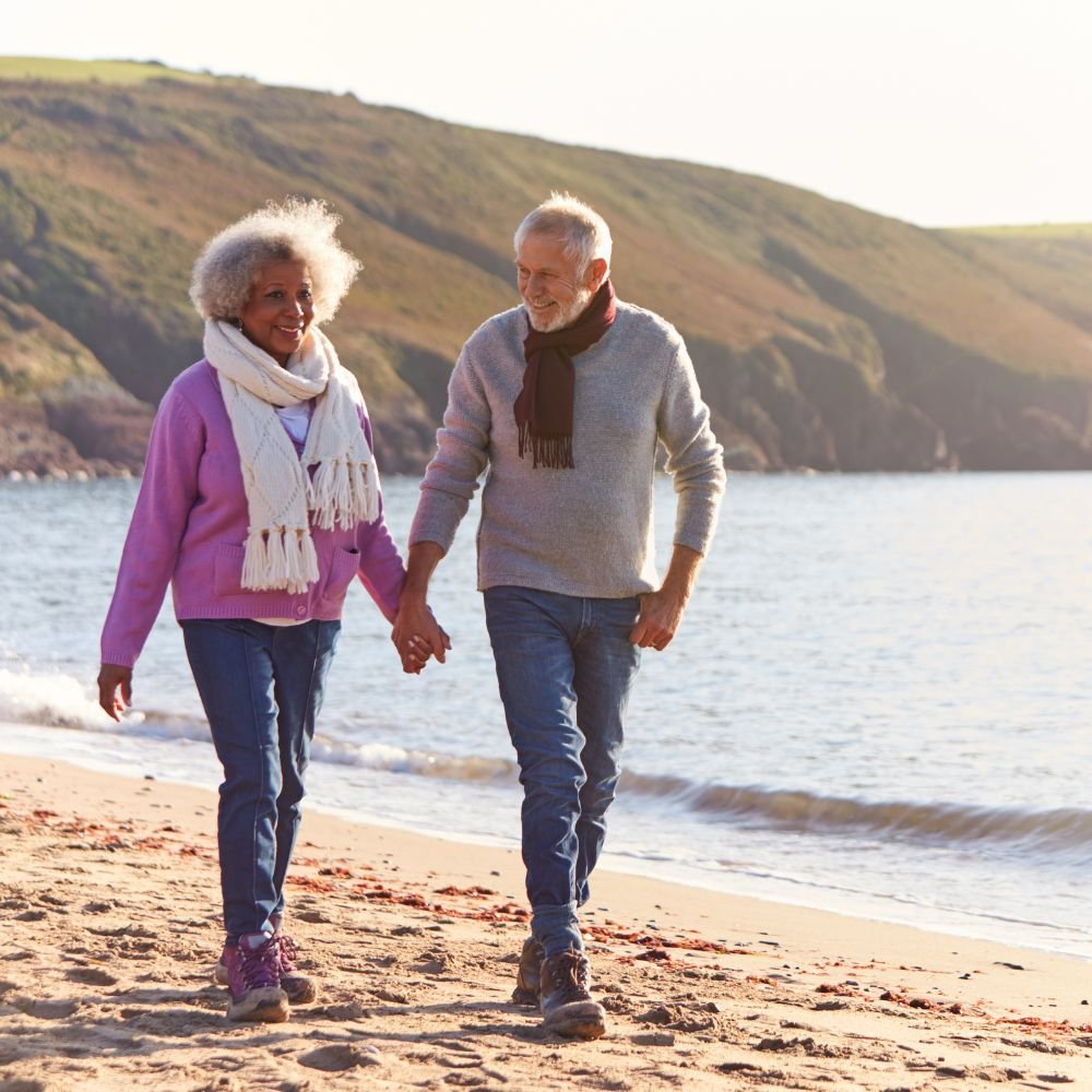 happy couple walking on beach