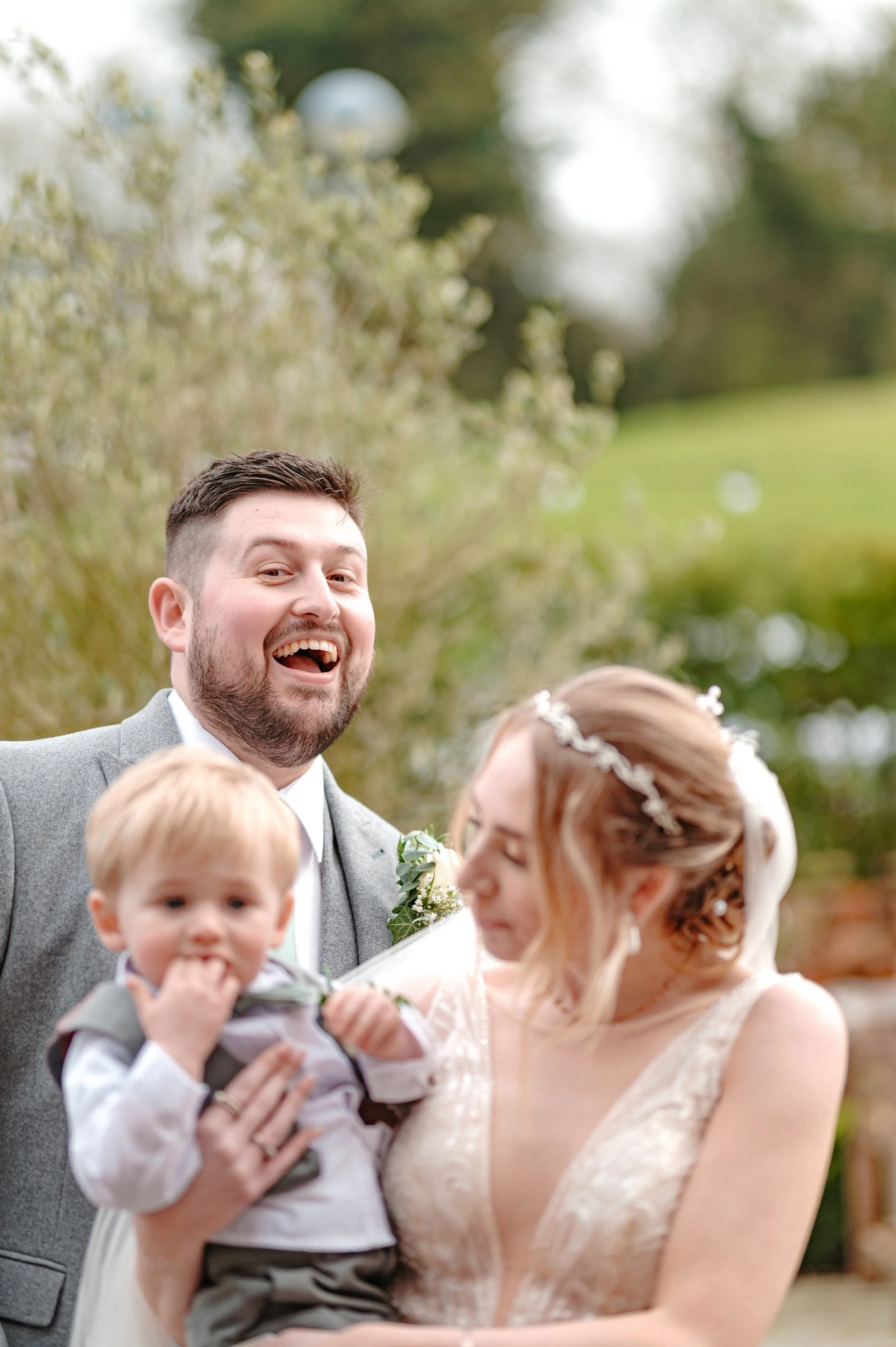 Elegant wedding couple walking through a country estate garden