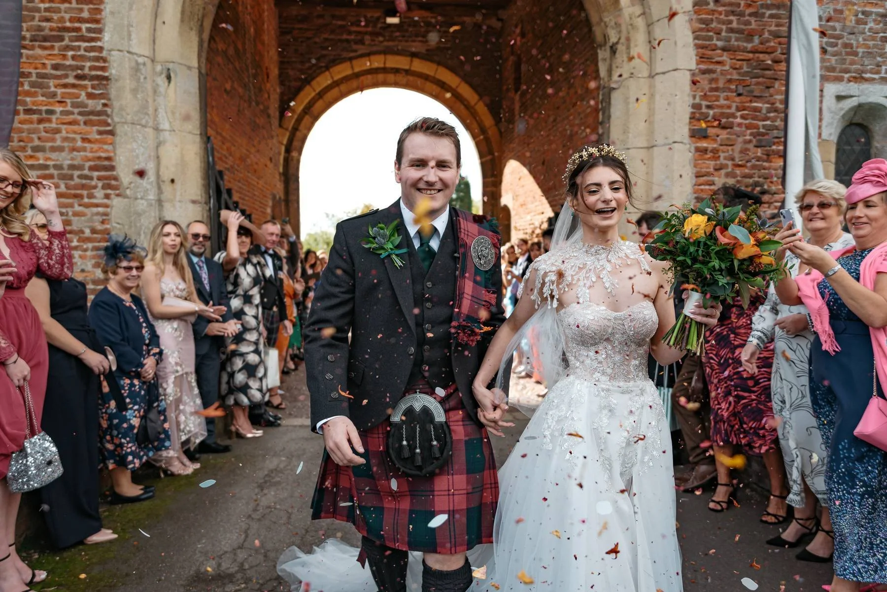 Bride and groom enjoying a confetti exit